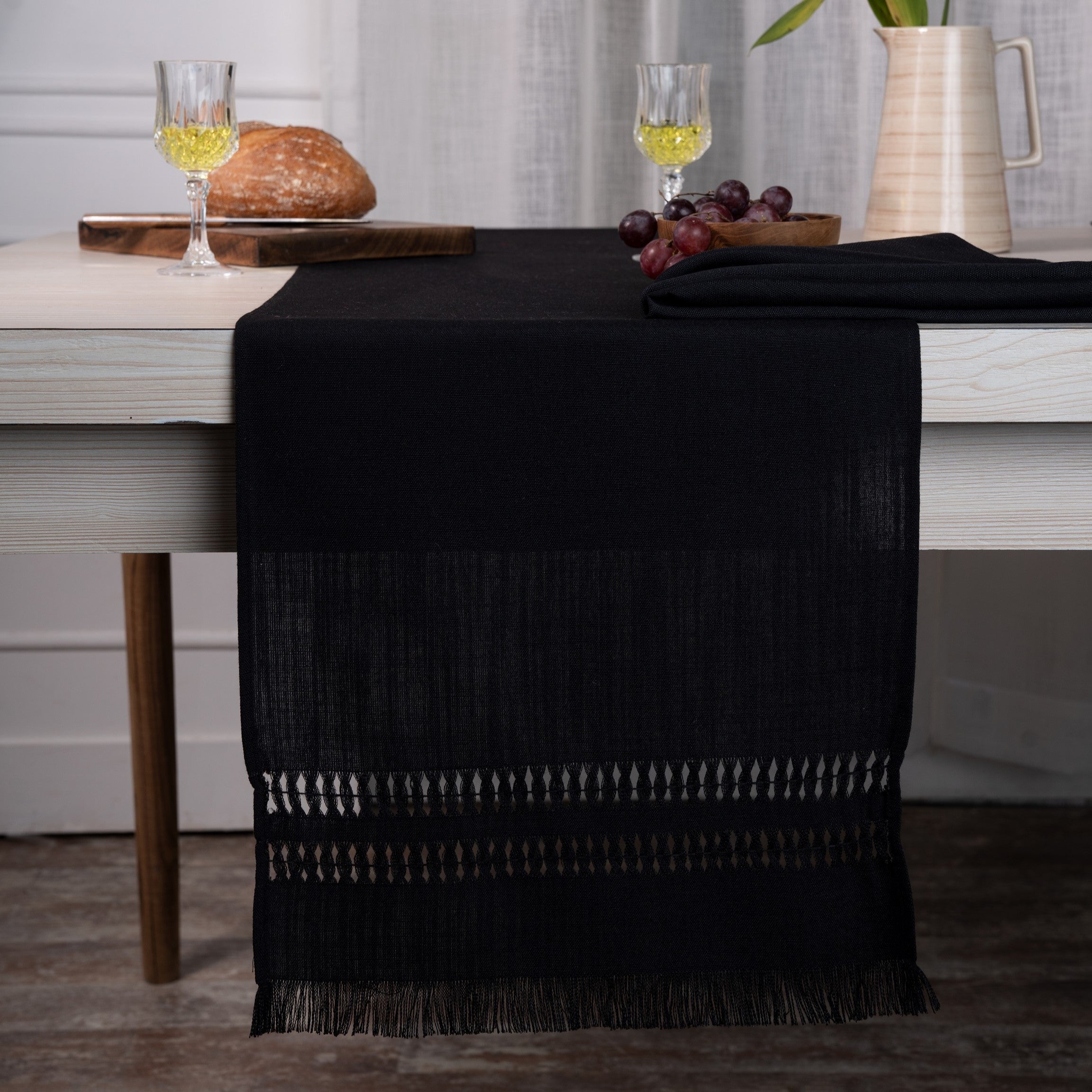 Black faux linen table runner styled on a dining table