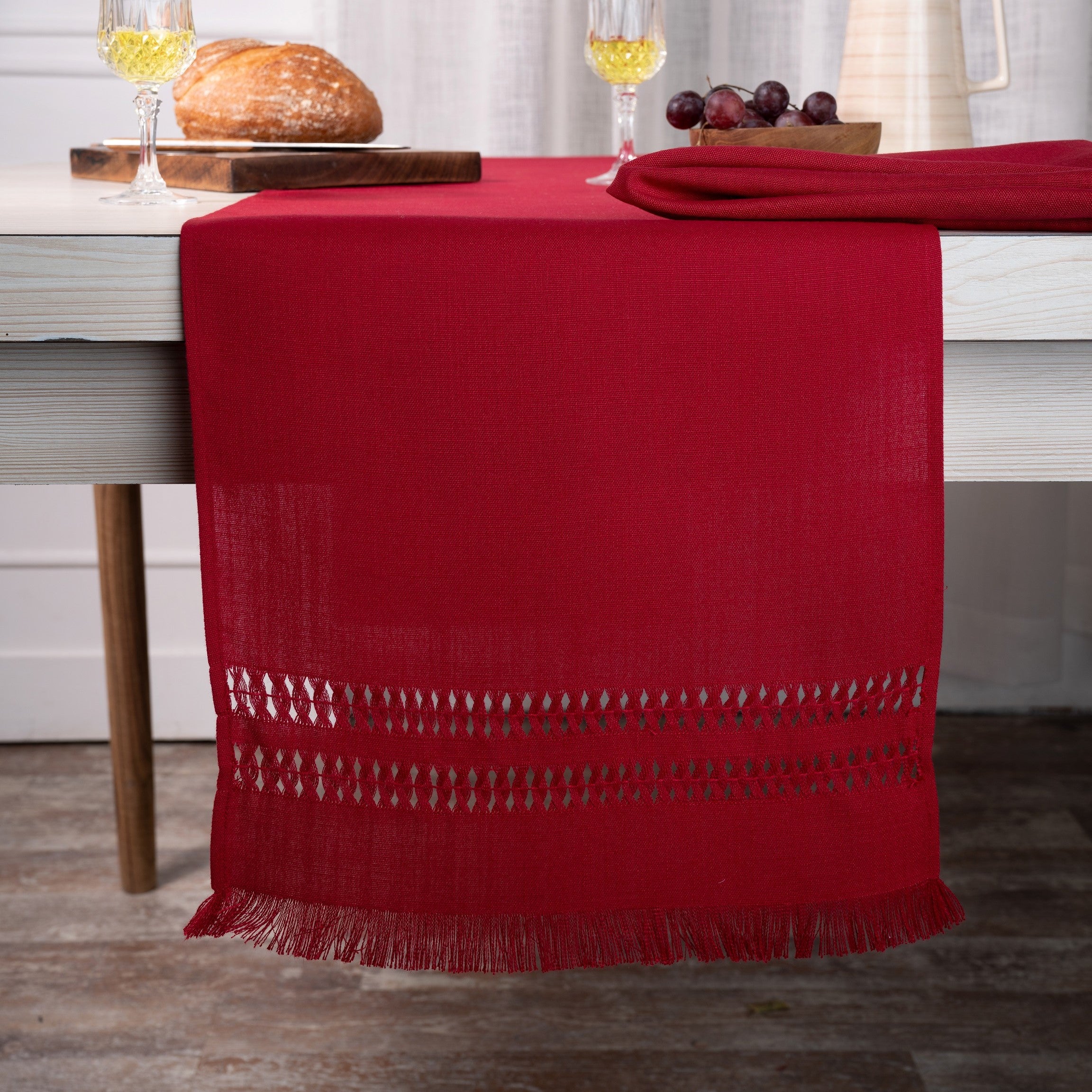 Red faux linen table runner styled on a dining table