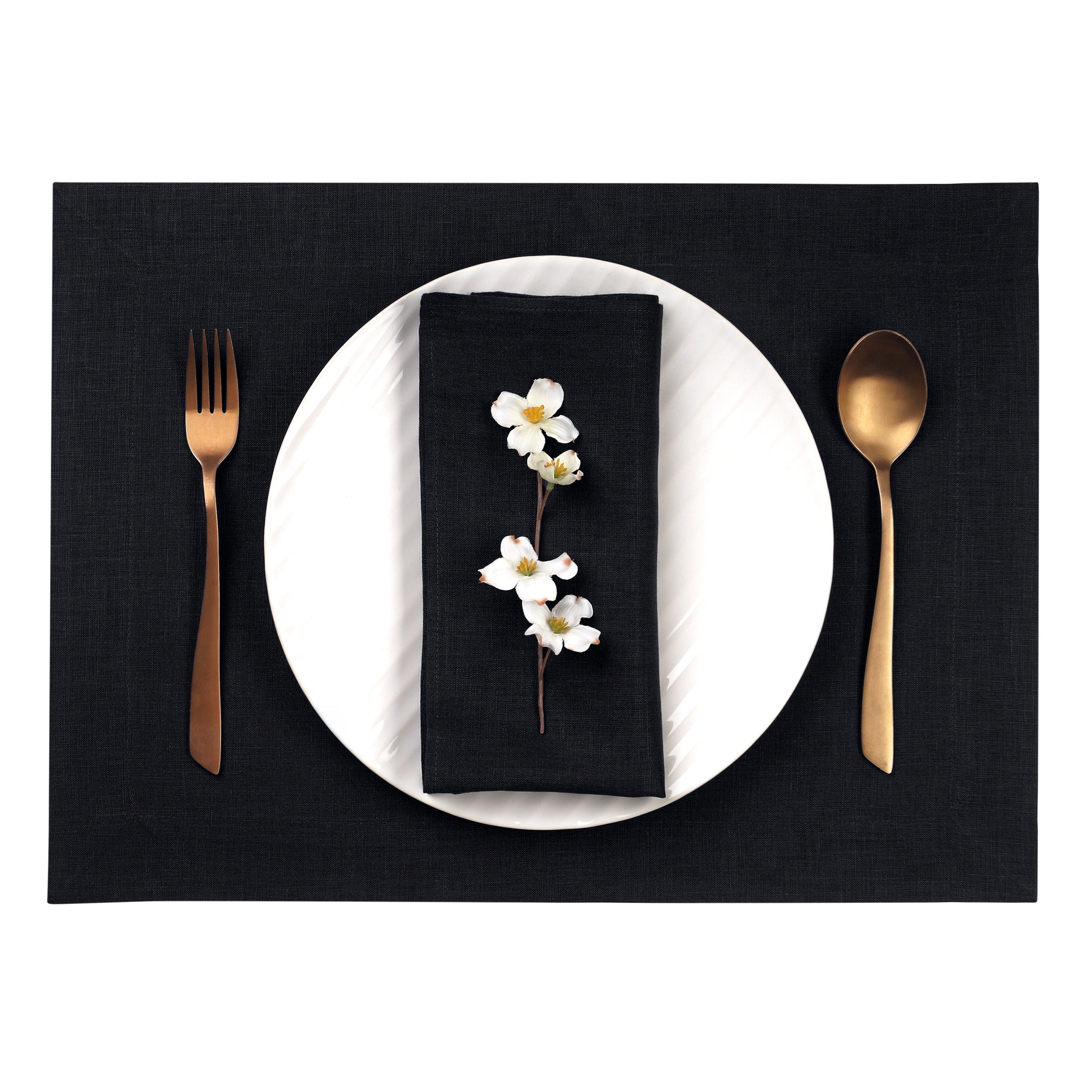 Close-up of the hemmed edge on black linen placemats