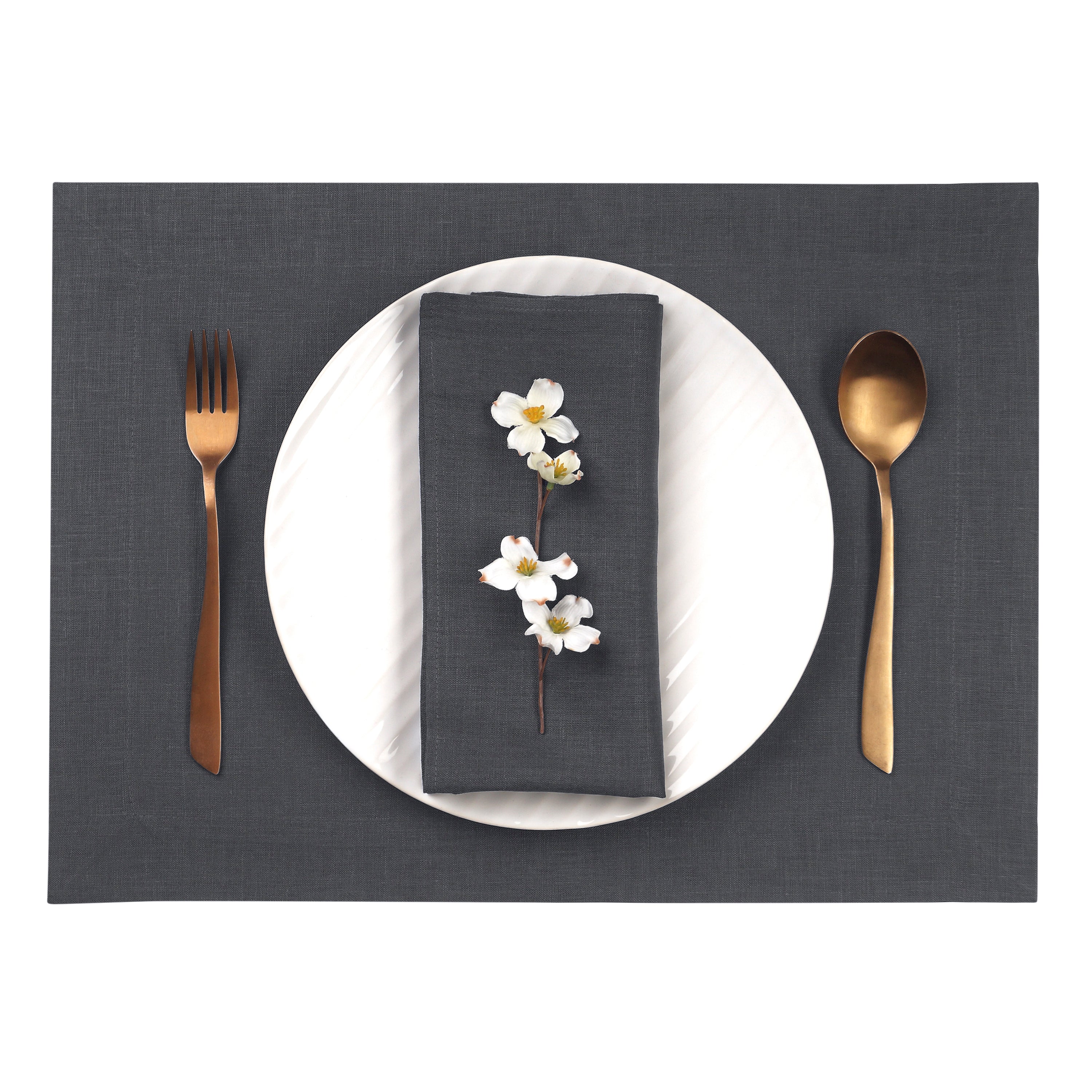Close-up of the hemmed edge on charcoal grey linen placemats
