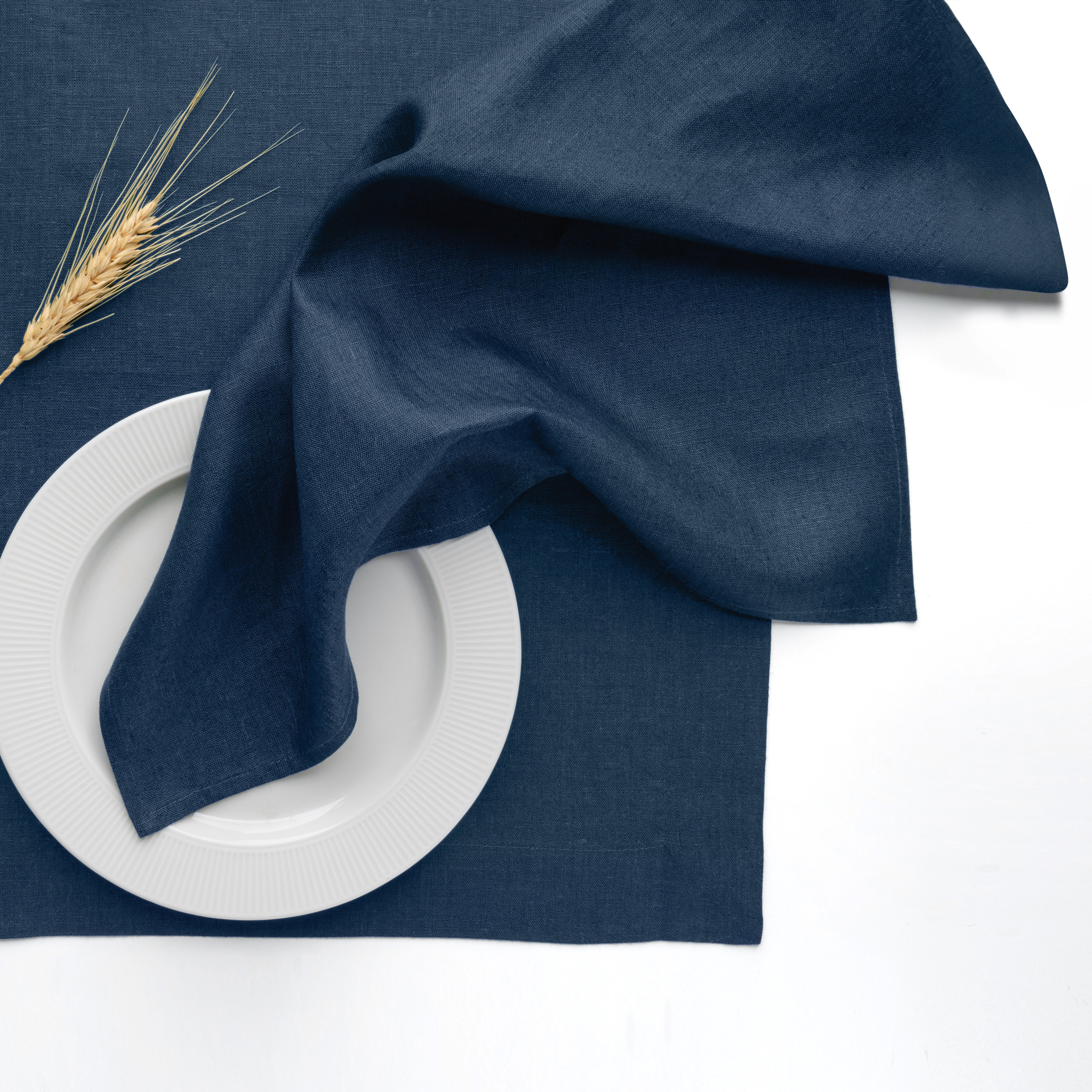 Navy blue pure linen dinner napkins styled on a dining table