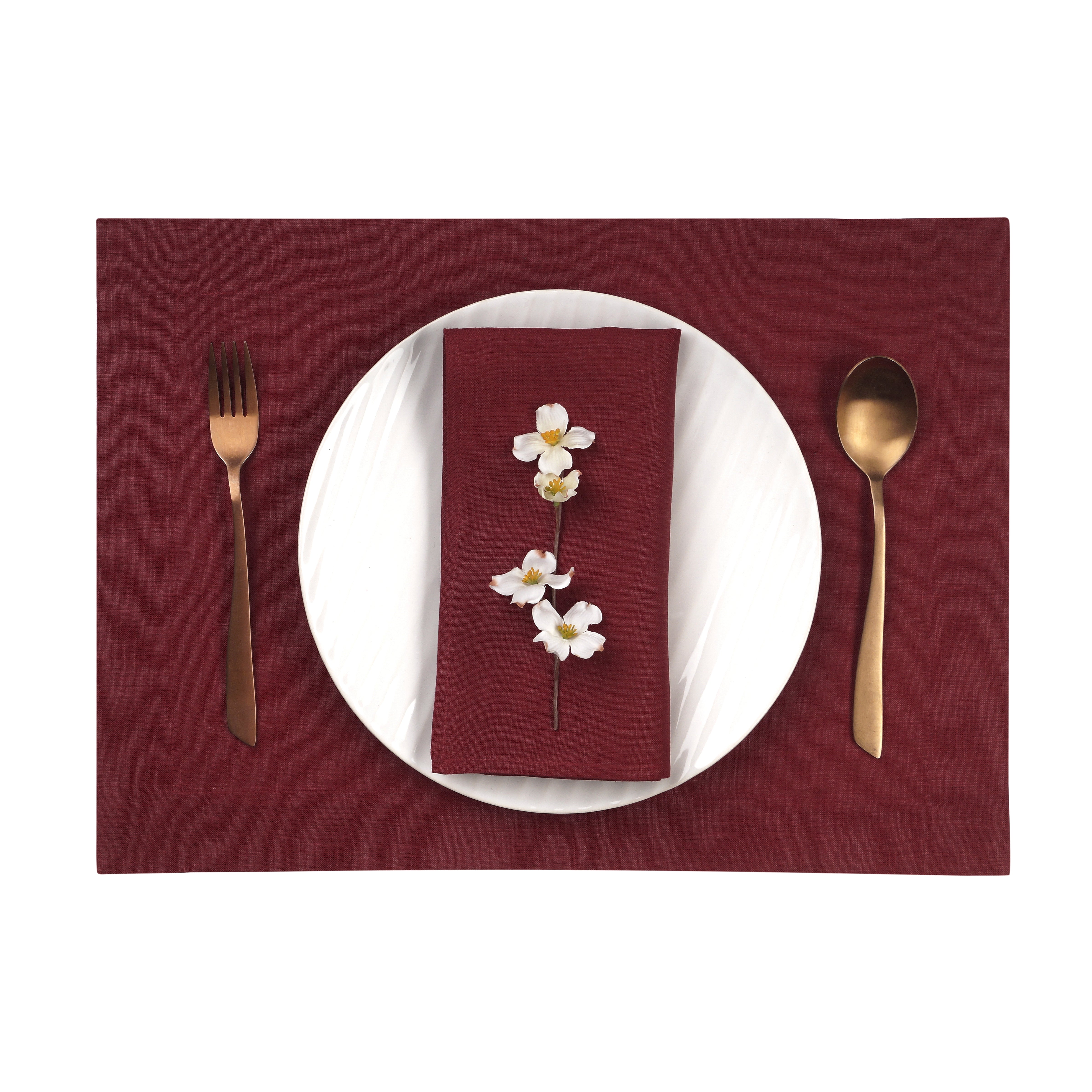 Close-up of the hemmed edge on dark red linen placemats