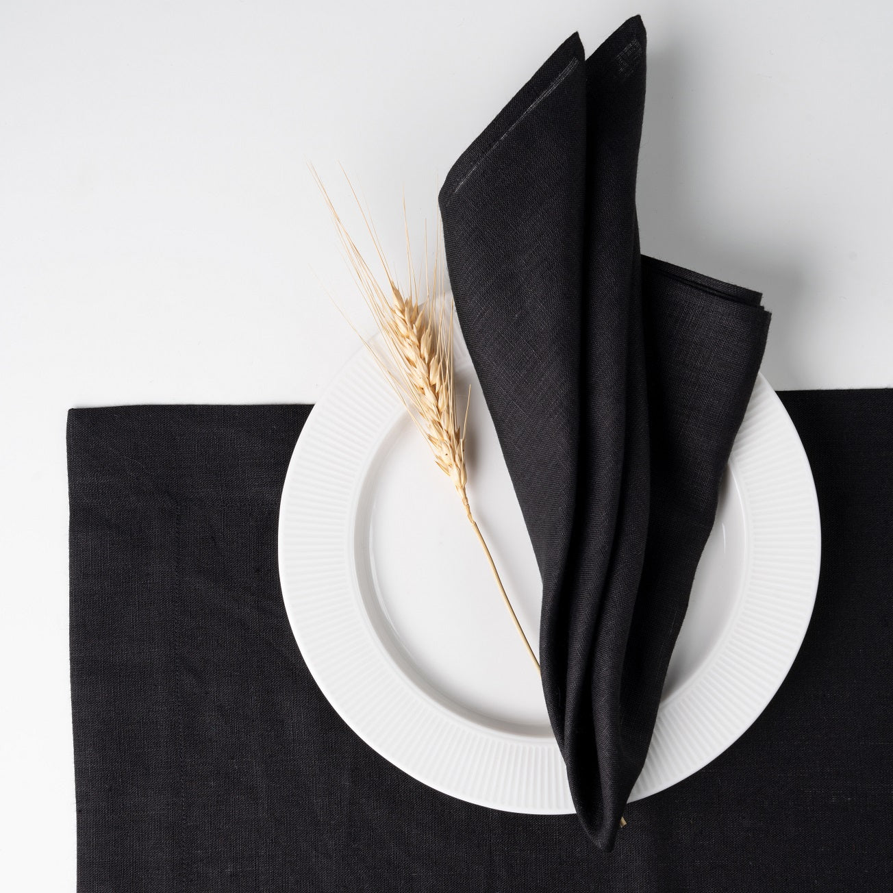 Black pure linen dinner napkins styled on a dining table