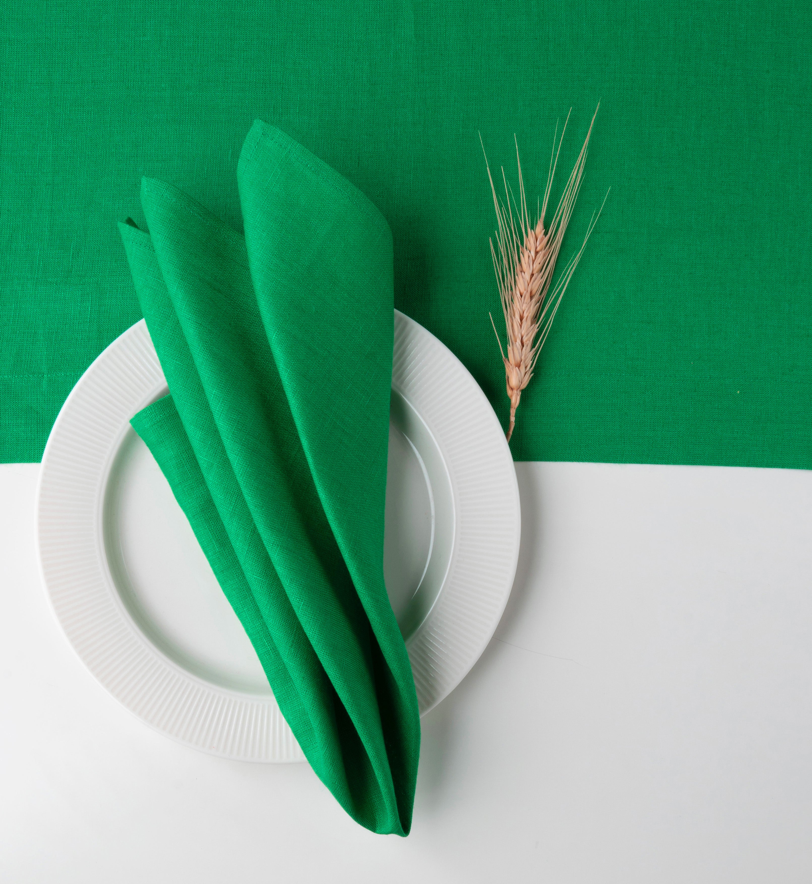 Kelly green pure linen dinner napkins styled on a dining table