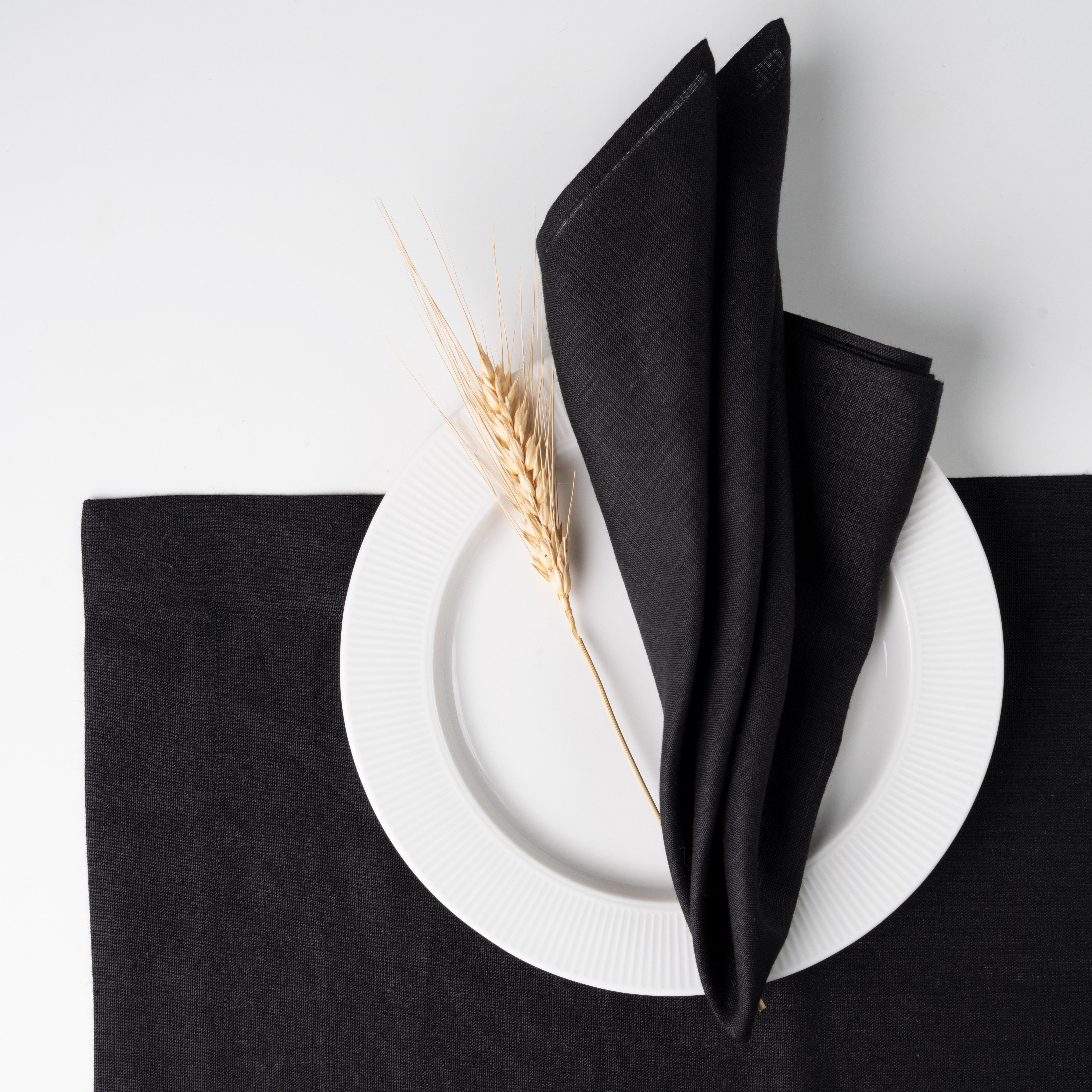 Close-up of the mitered corners on black pure linen dinner napkins