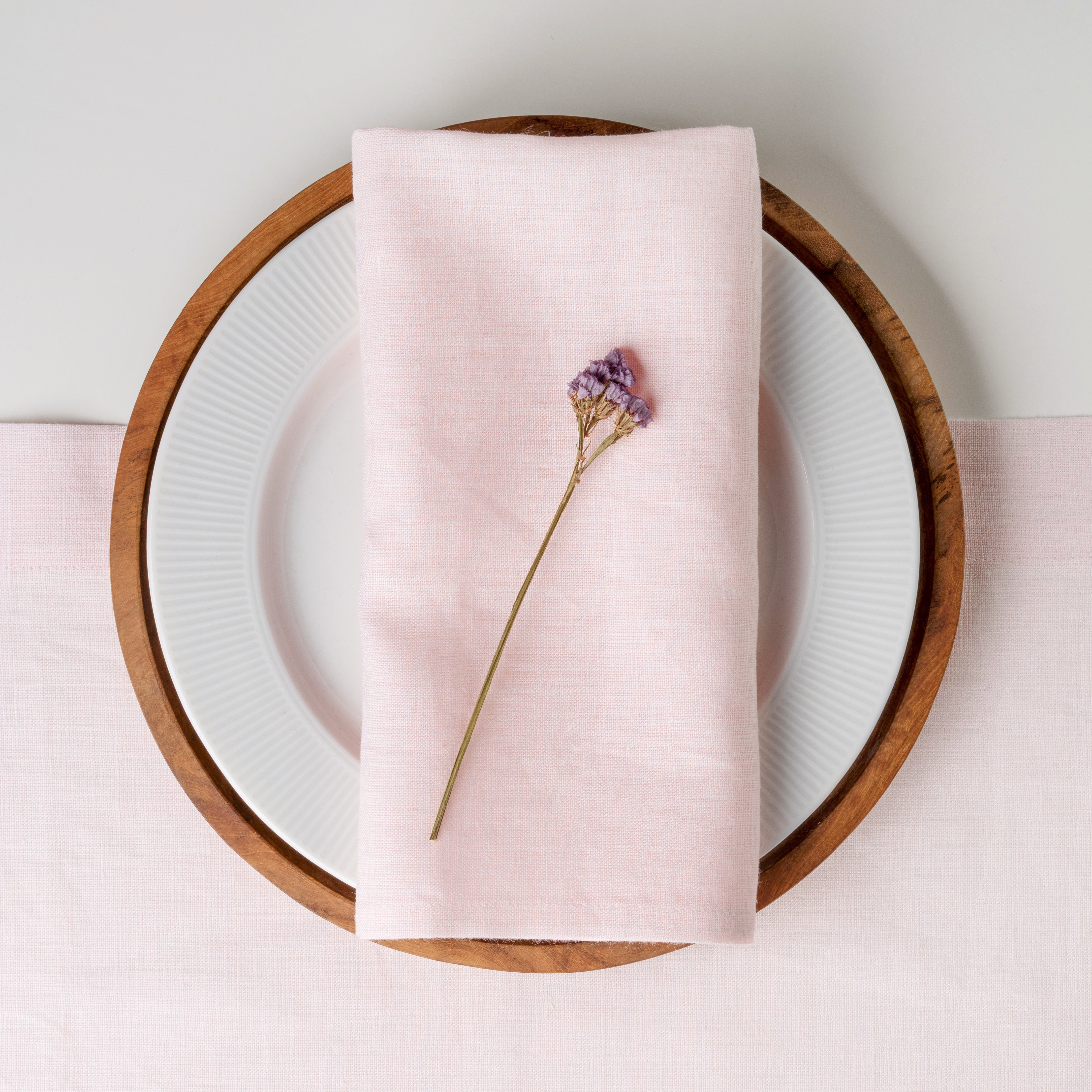 Pastel pink pure linen dinner napkins styled on a dining table