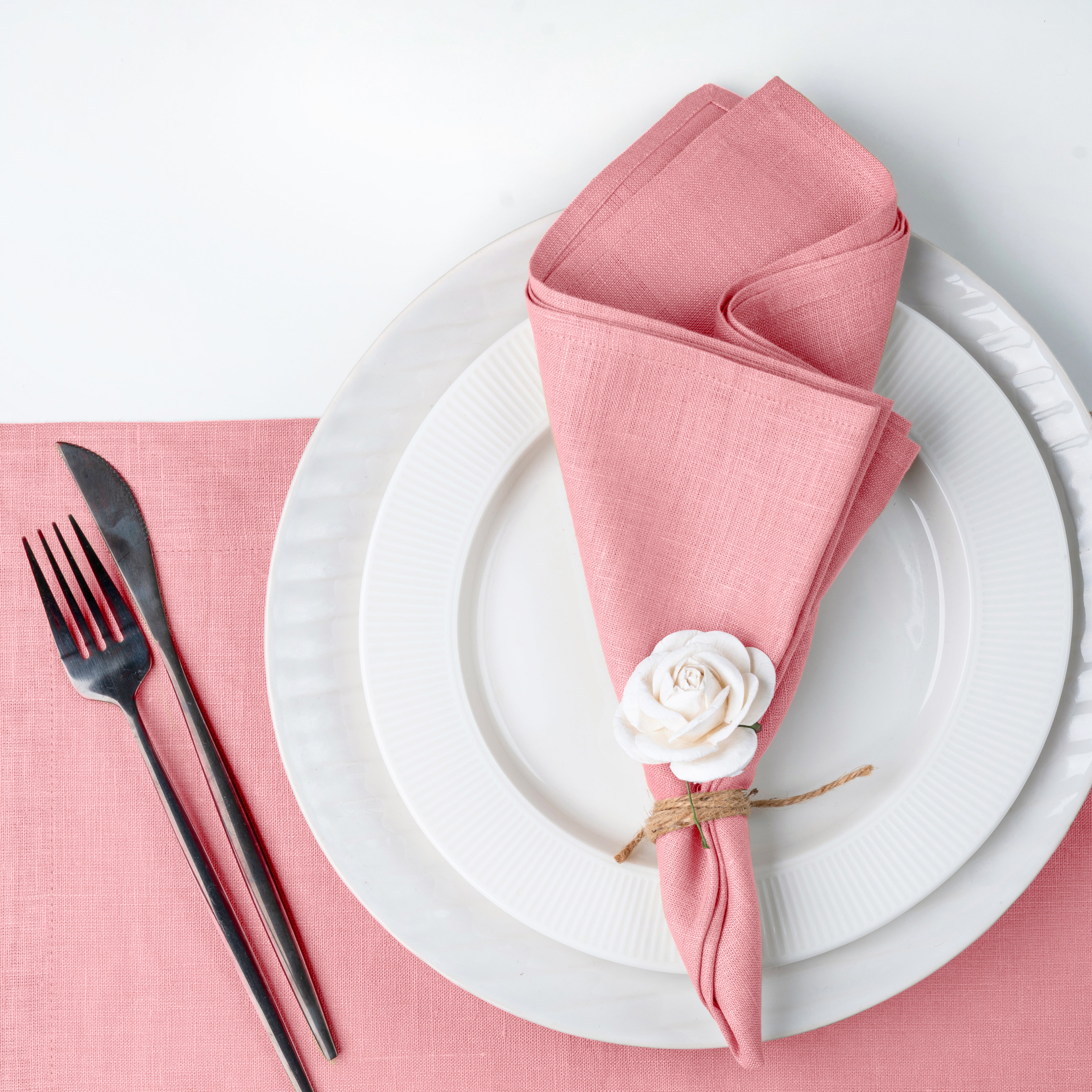 Close-up of the mitered corners on dusty pink pure linen dinner napkins