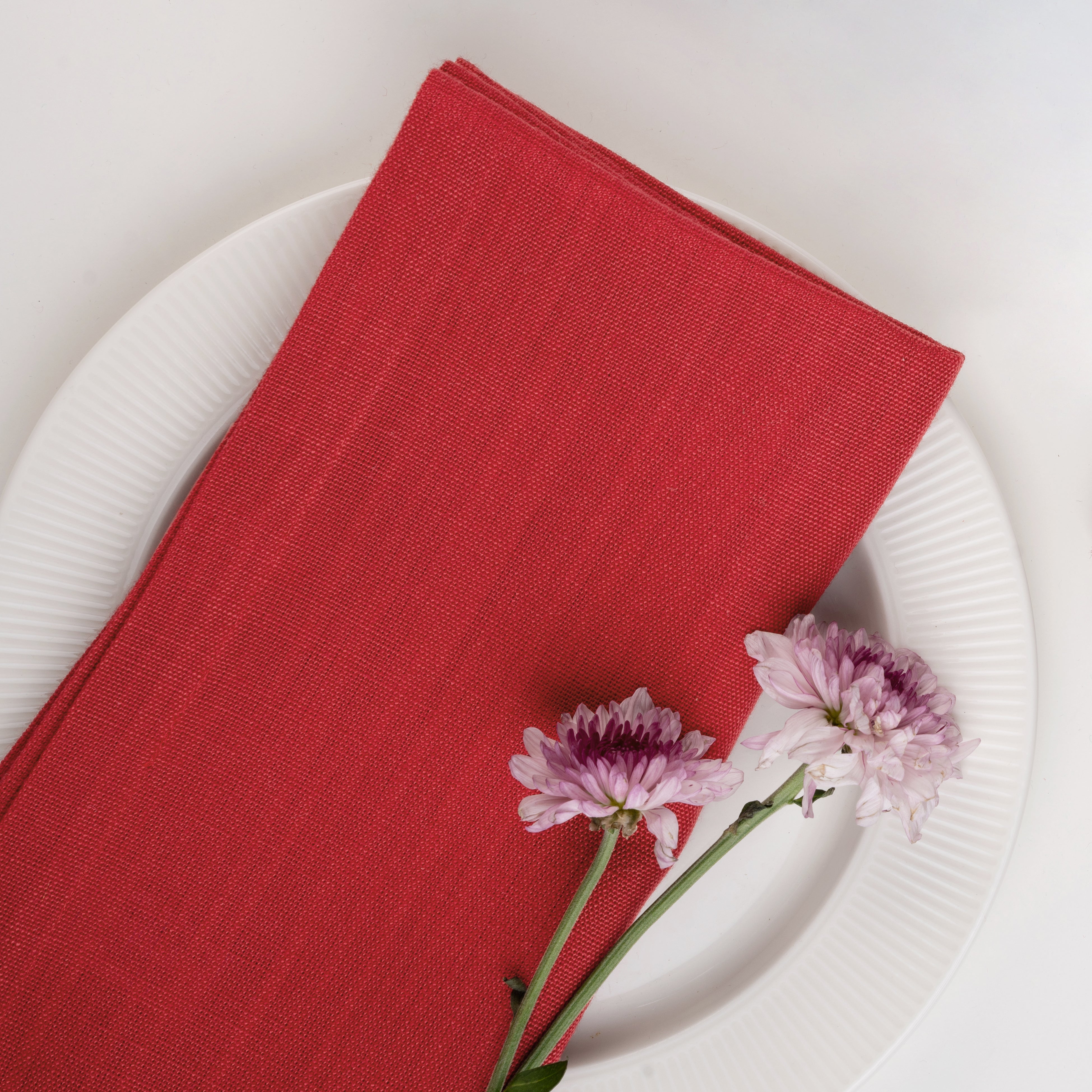Bright red pure linen dinner napkins styled on a dining table
