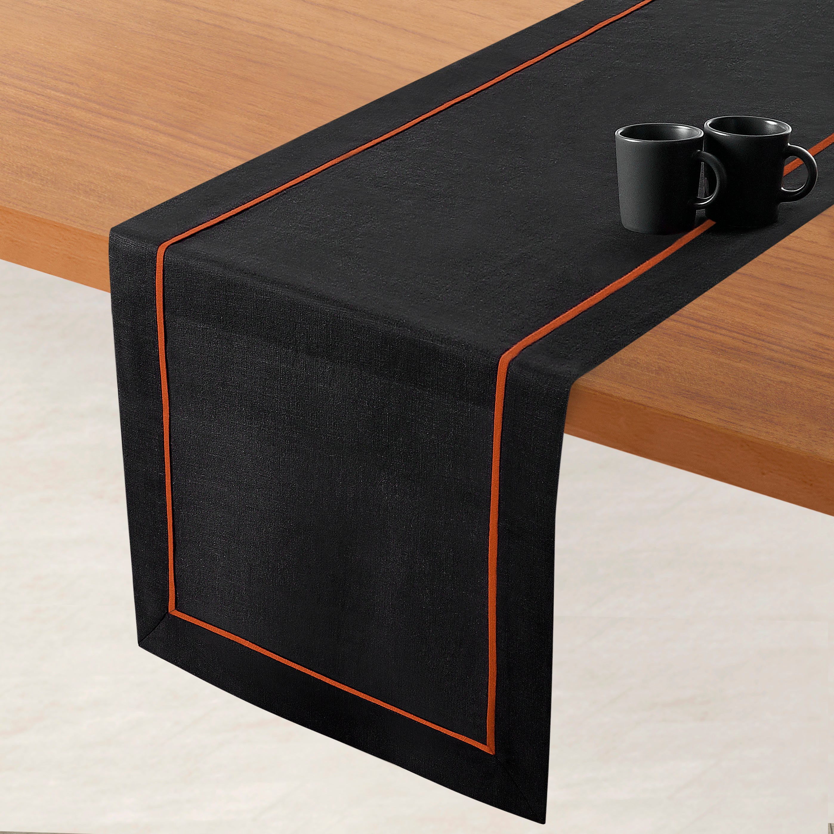 Black and rust pure linen table runner styled on a dining table