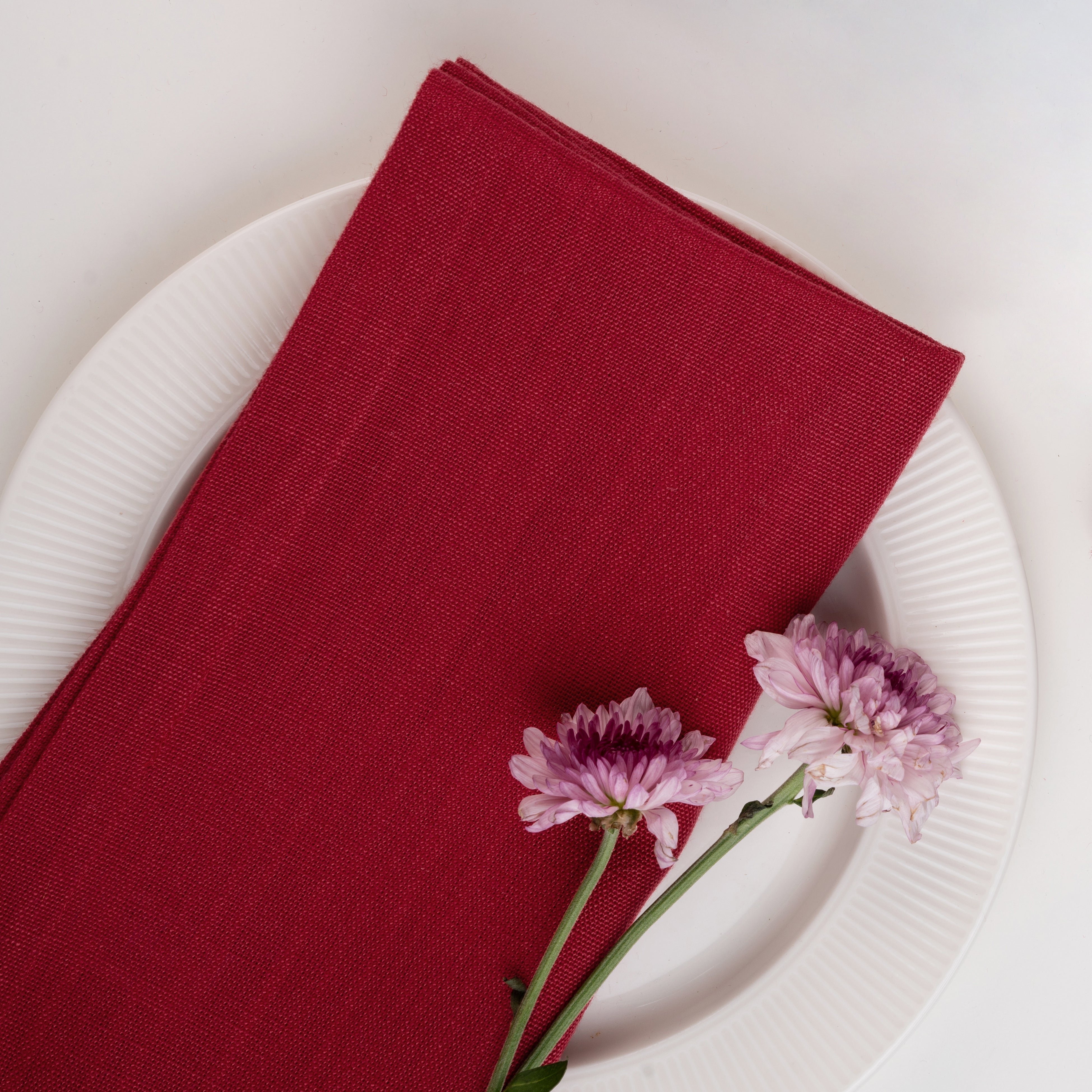 Red pure linen dinner napkins styled on a dining table