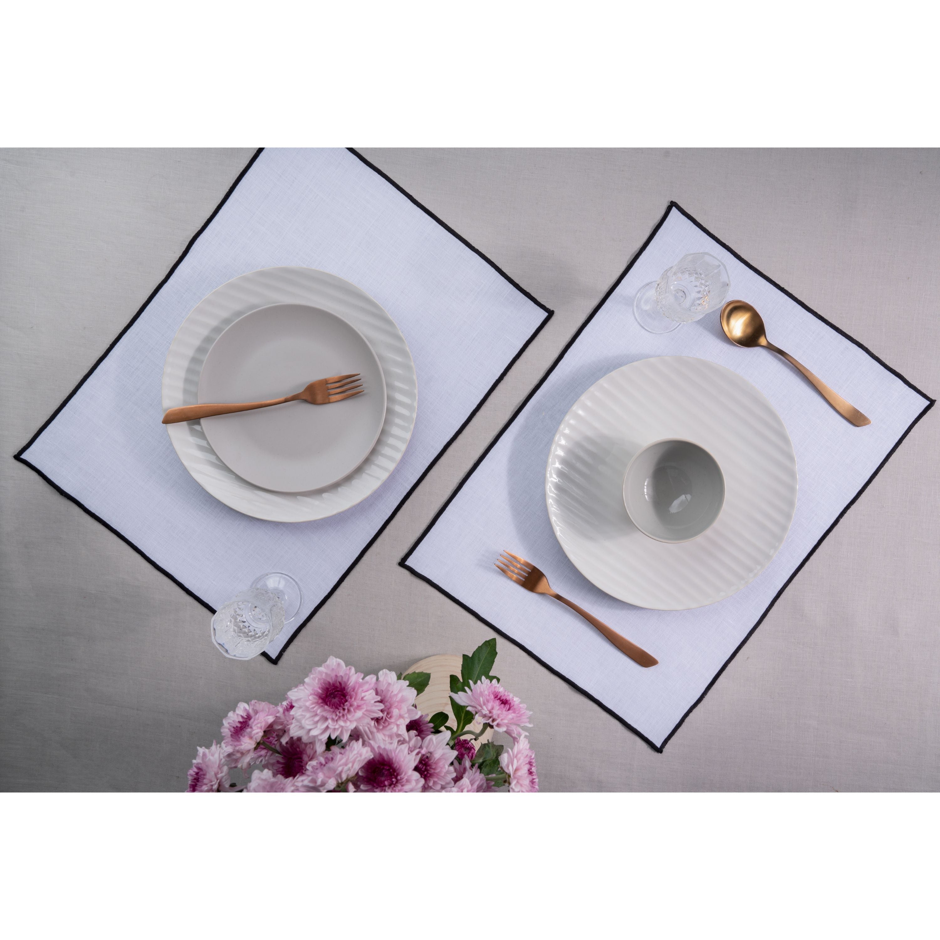 White and navy blue pure linen placemats styled on a dining table