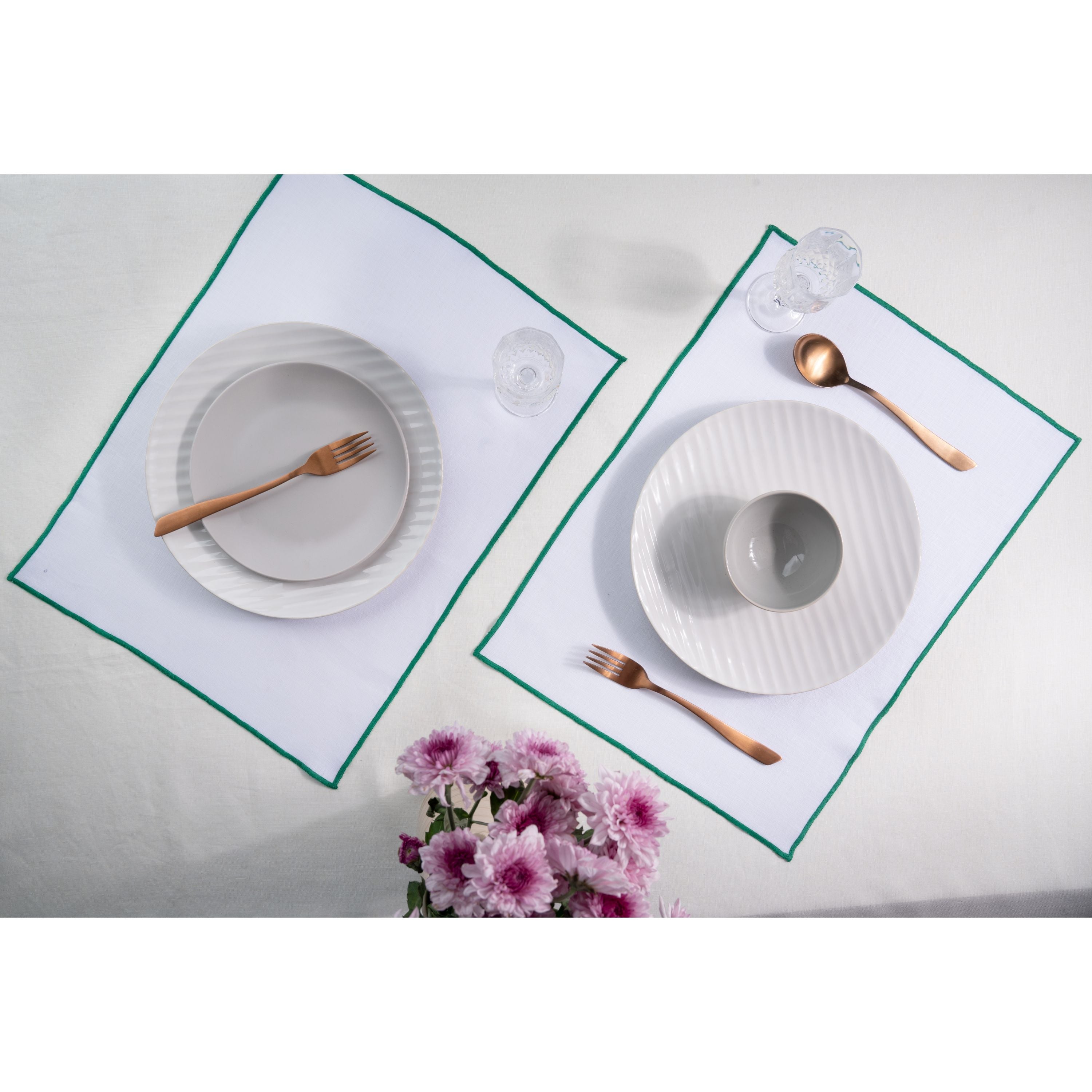 White and green pure linen placemats styled on a dining table