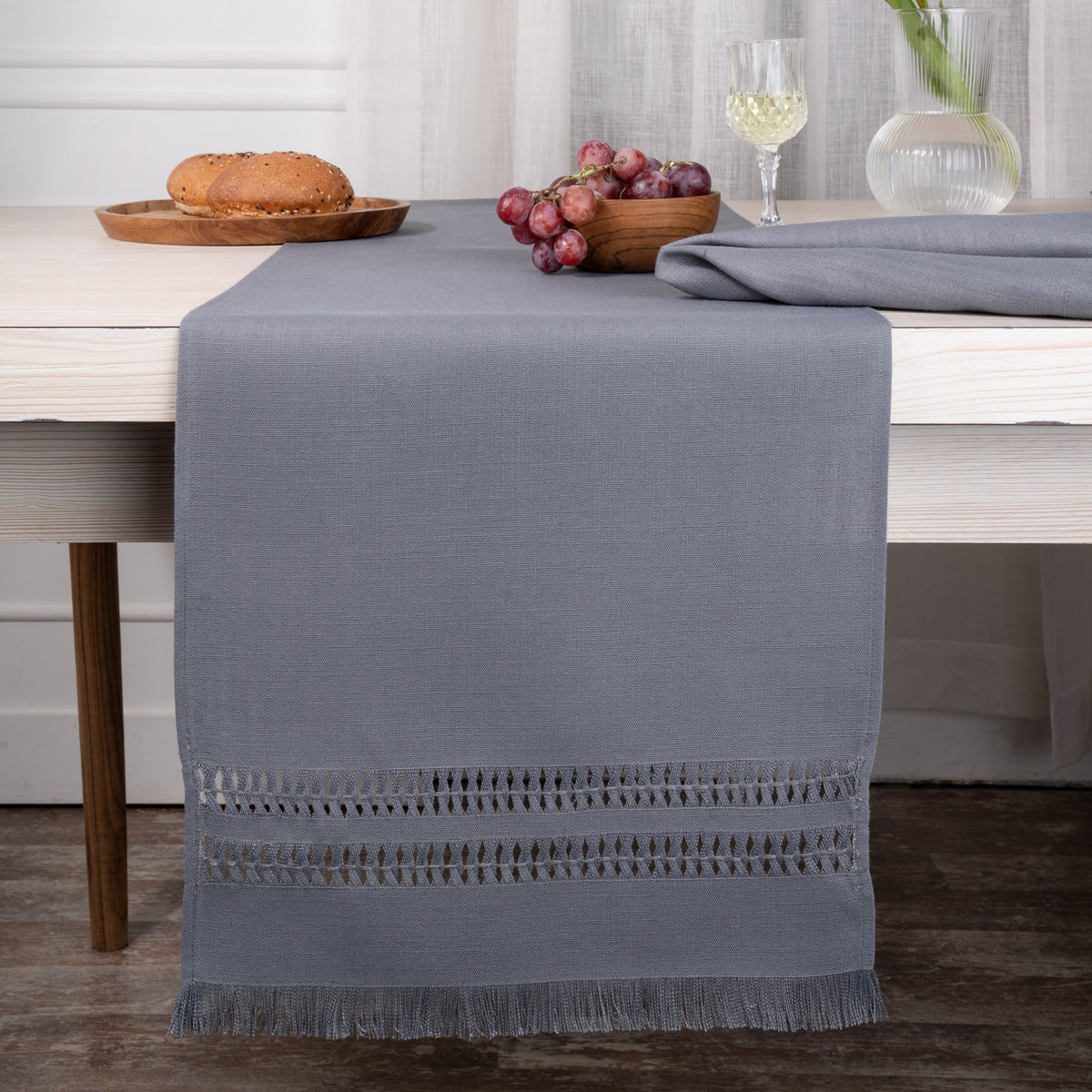 Charcoal grey faux linen table runner styled on a dining table