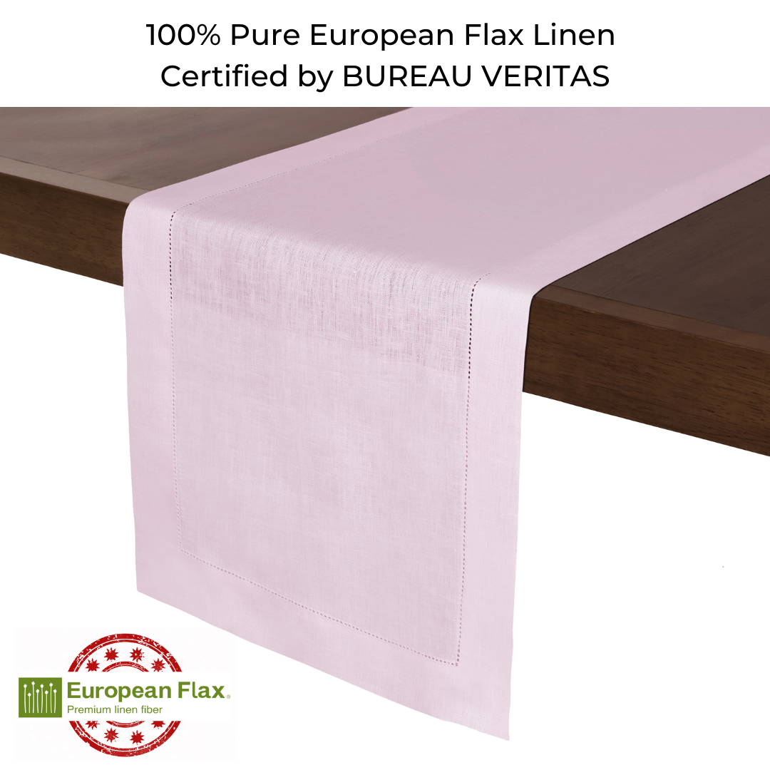 Pastel pink linen table runner styled on a dining table