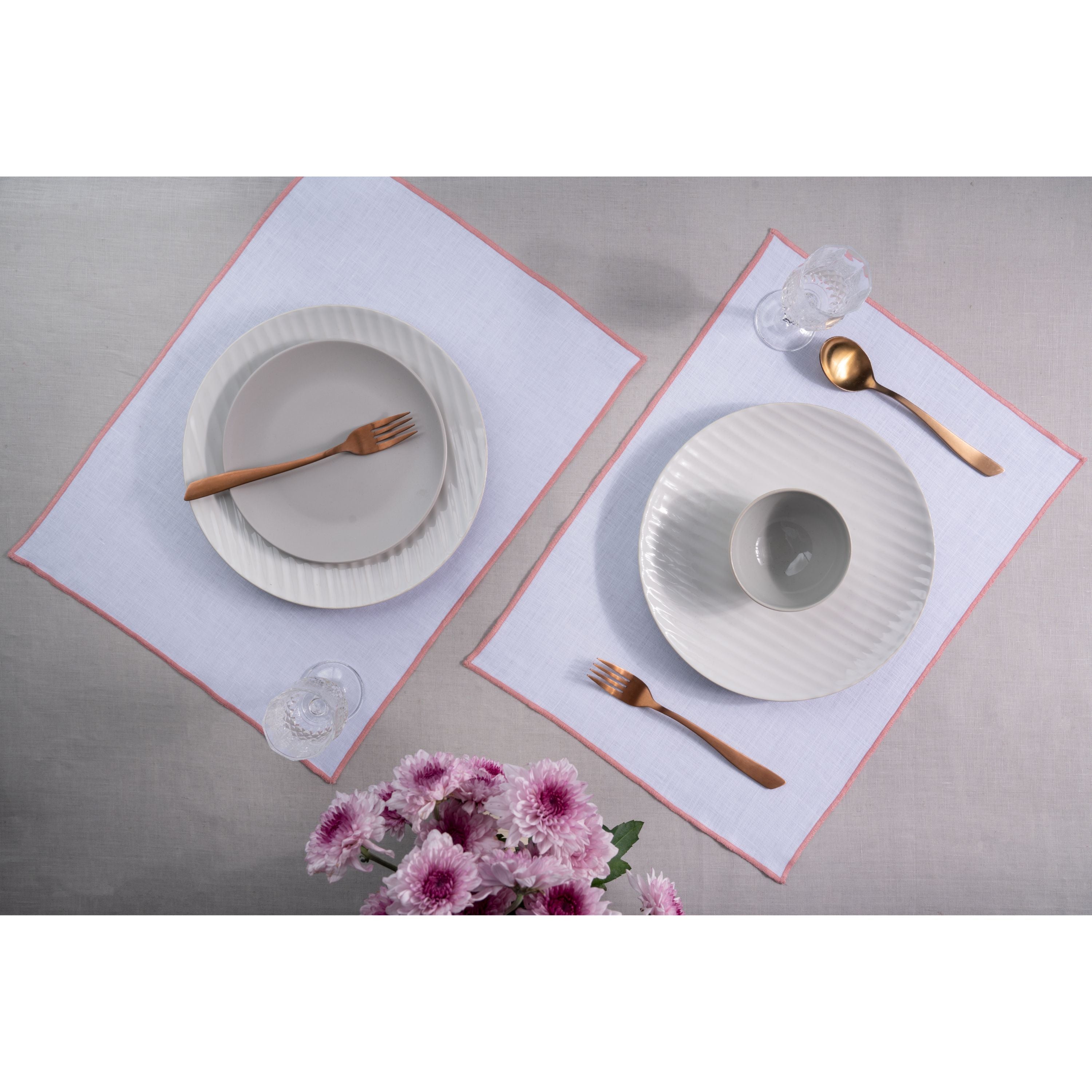 White and dusty pink pure linen placemats styled on a dining table