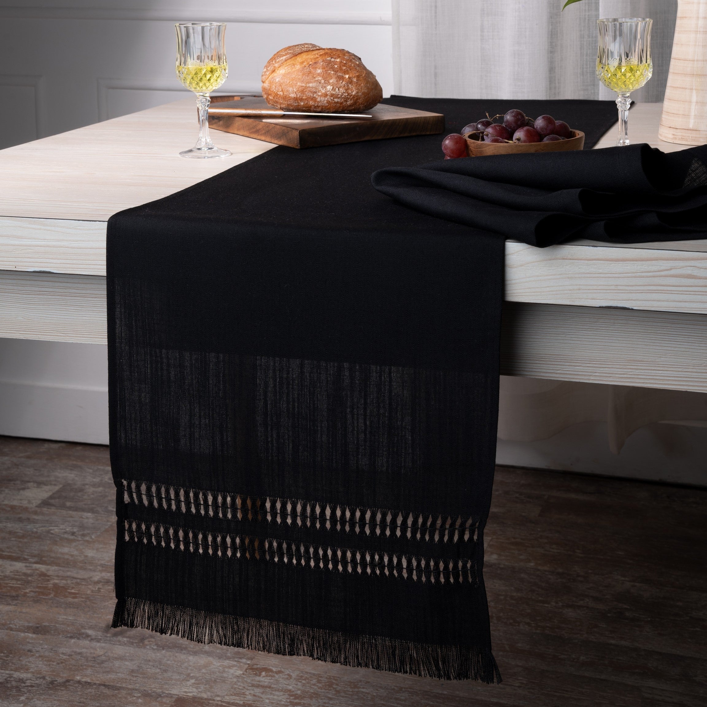 Close-up of the hand-hemstitch edge on a black faux linen table runner