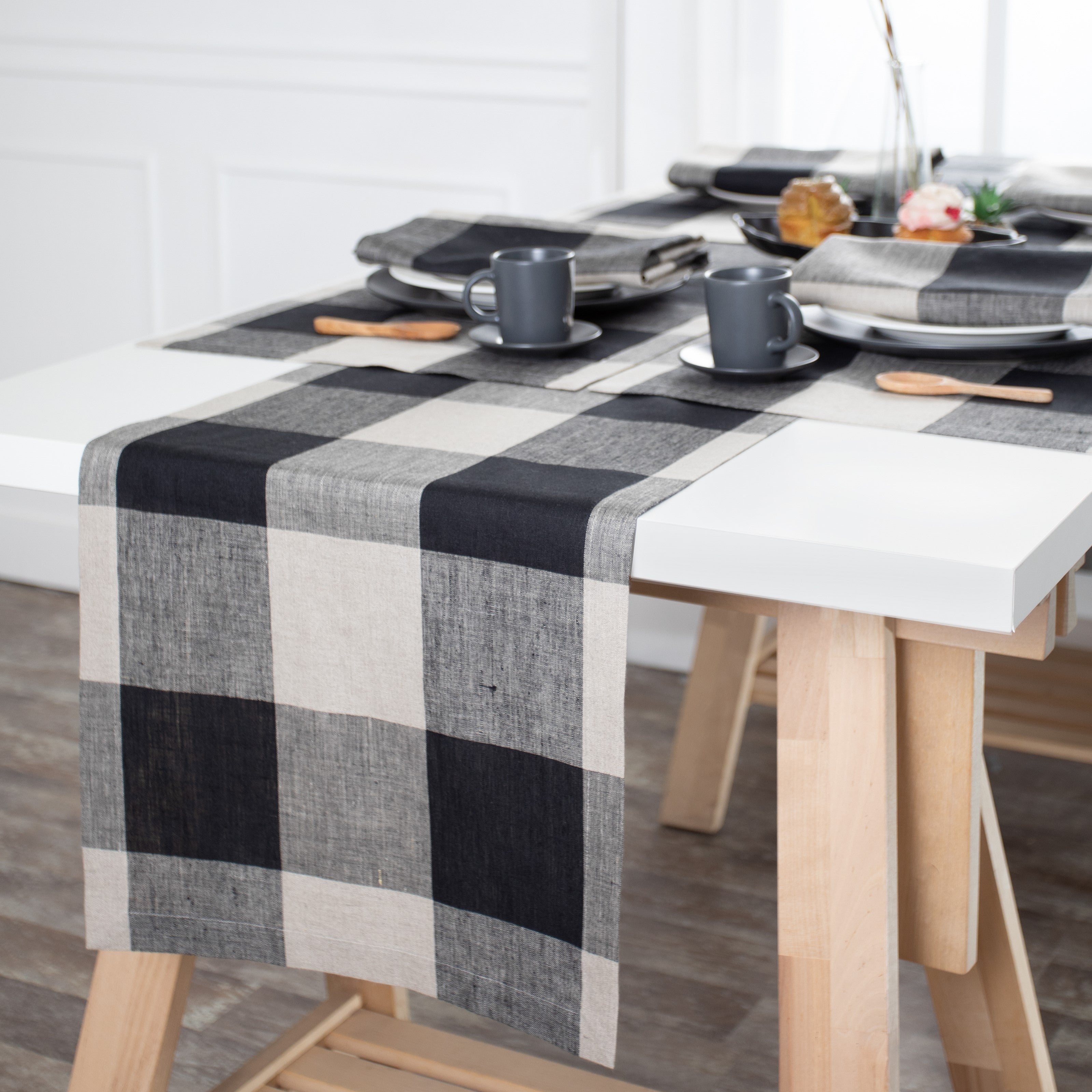 Natural and black pure linen table runner styled on a dining table