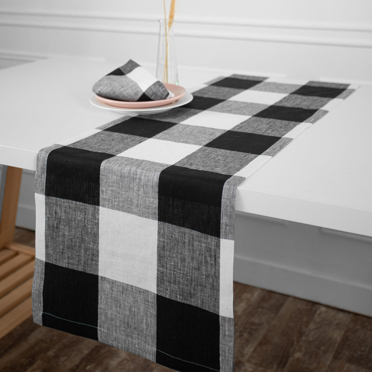 White and black pure linen table runner styled on a dining table