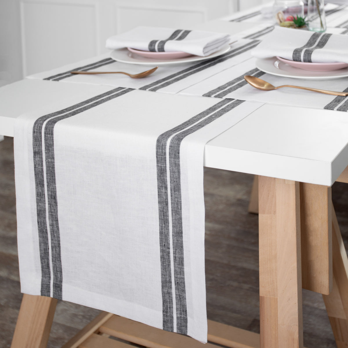 White and black pure linen table runner styled on a dining table