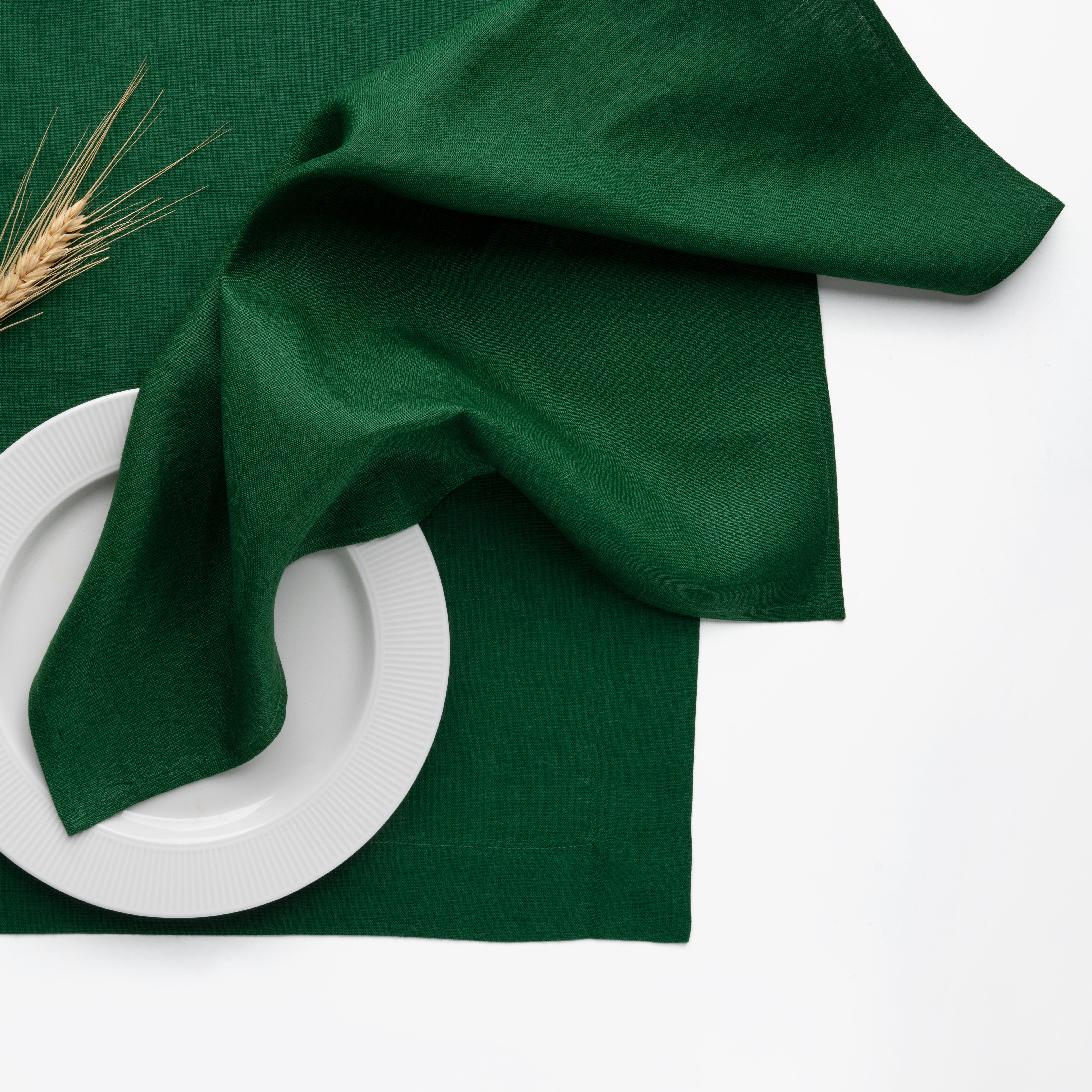Forest green pure linen dinner napkins styled on a dining table