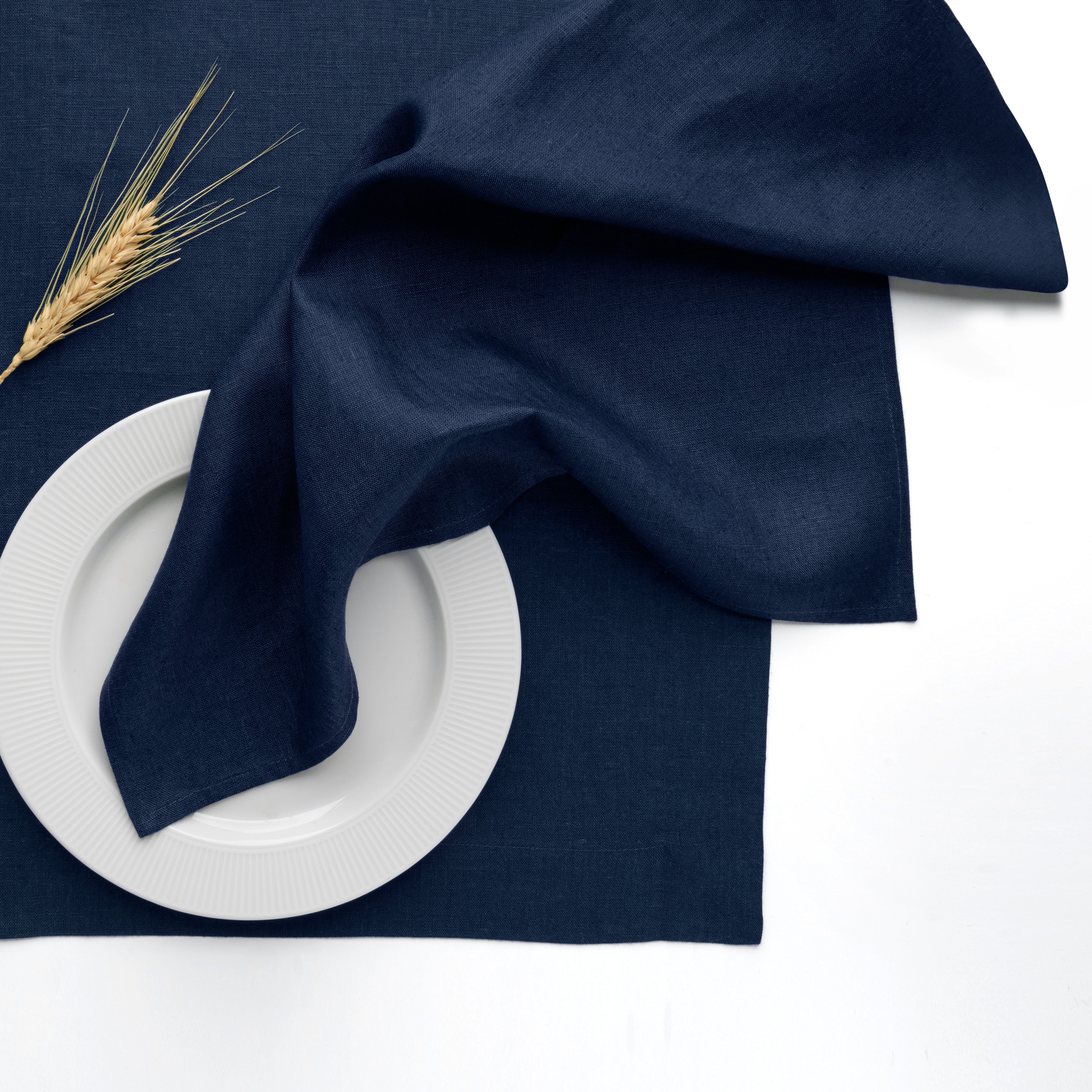 Navy blue pure linen dinner napkins styled on a dining table