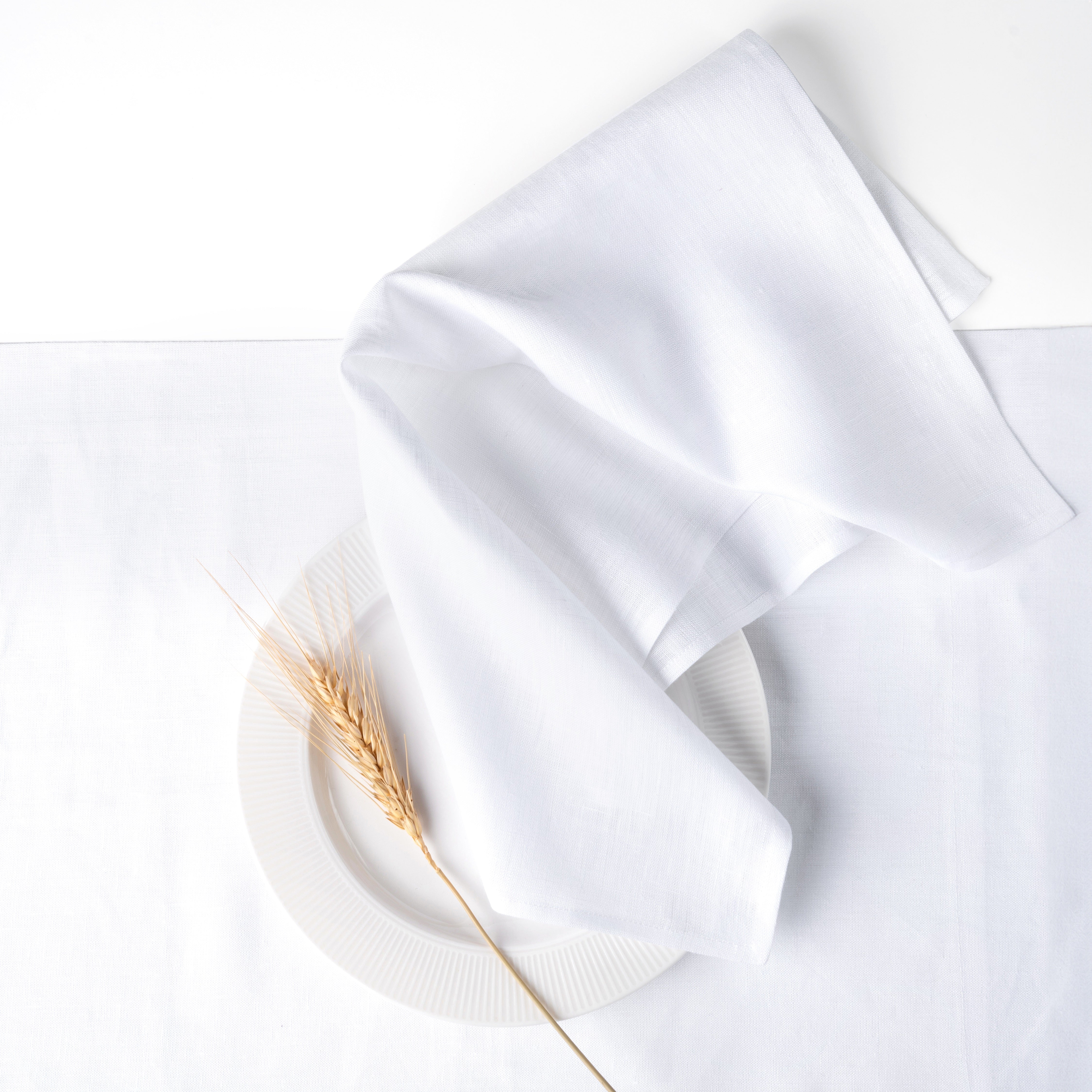 White pure linen dinner napkins with matching D'Moksha table linens