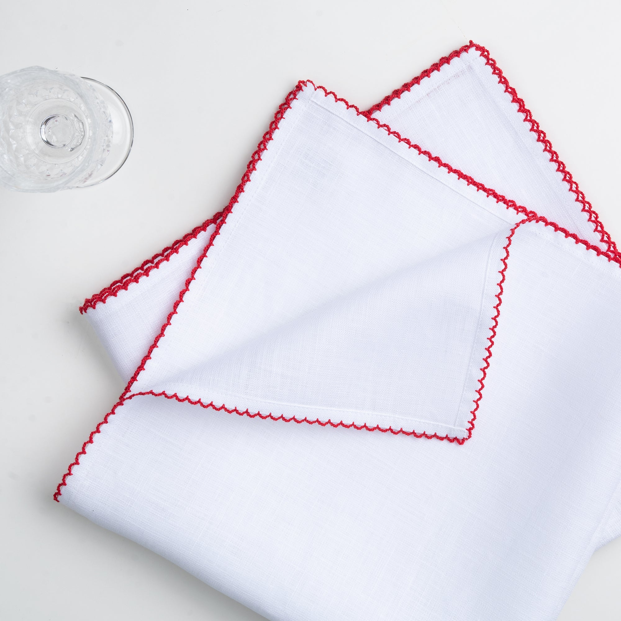 White and red pure linen dinner napkins styled on a dining table