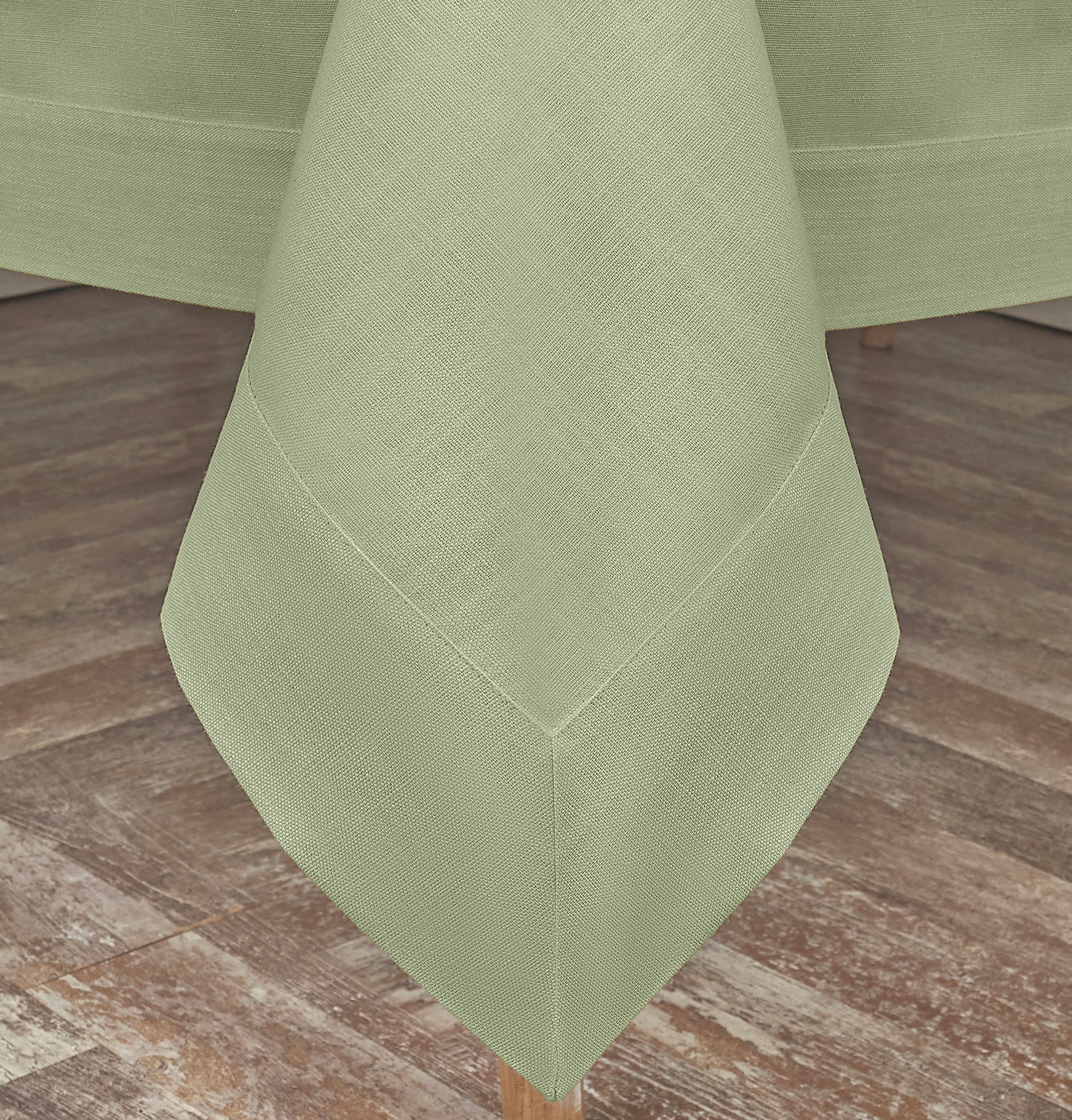 Sage green faux linen tablecloth styled on a dining table