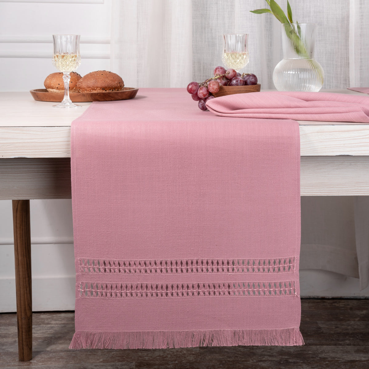 Dusty pink faux linen table runner styled on a dining table