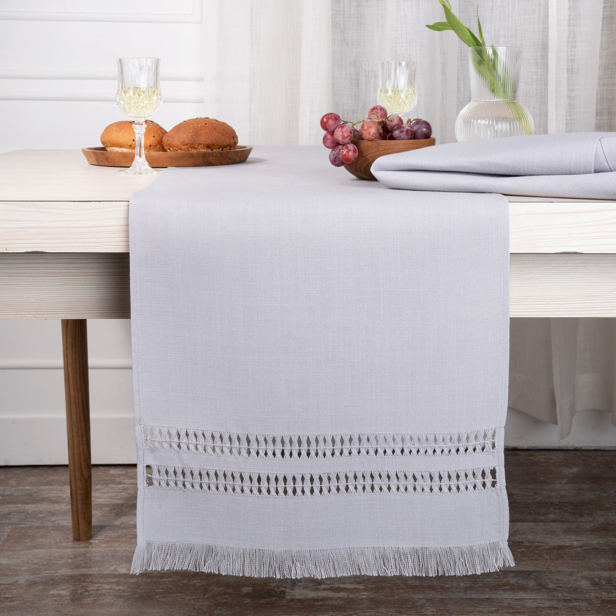Light grey faux linen table runner styled on a dining table