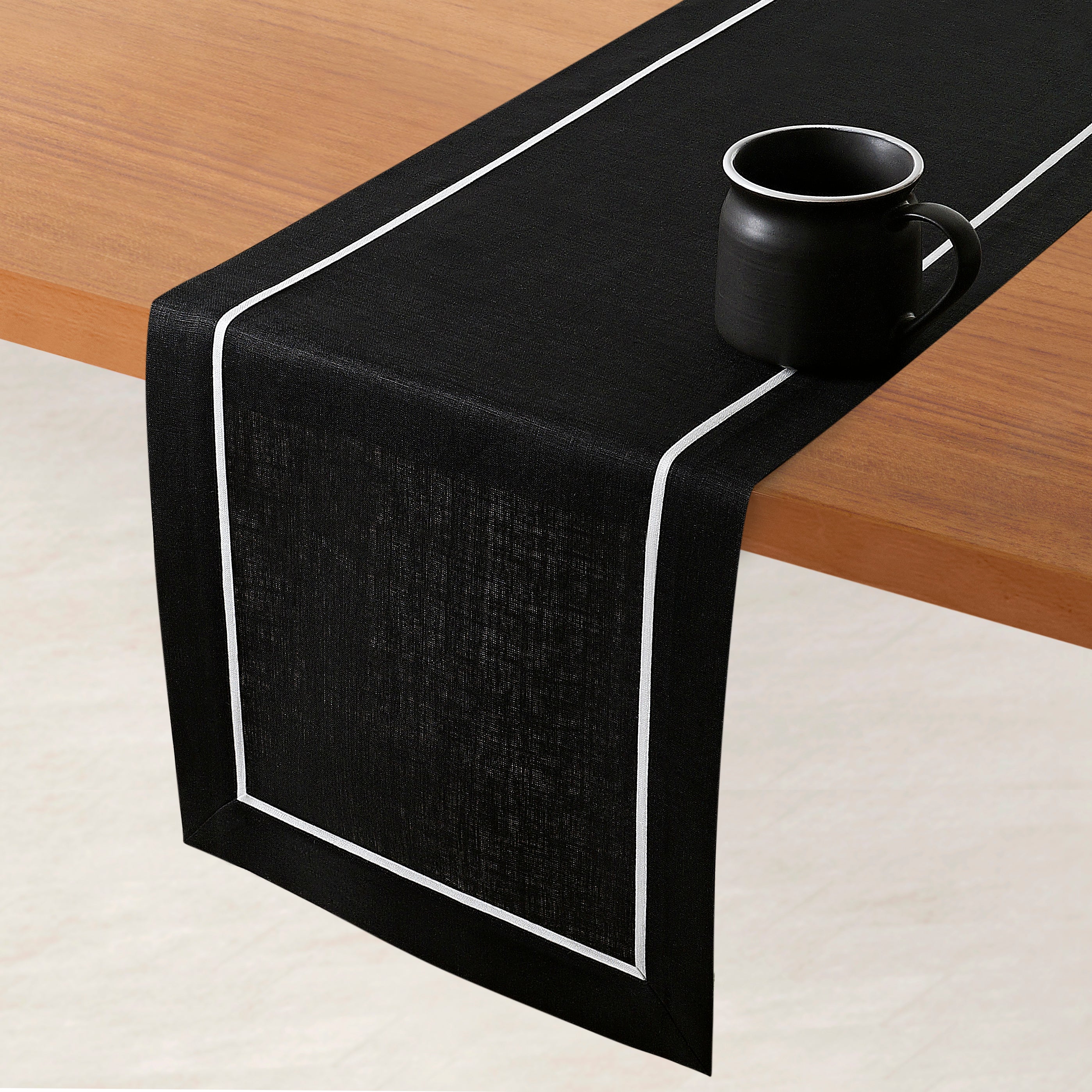 Black and white pure linen table runner styled on a dining table