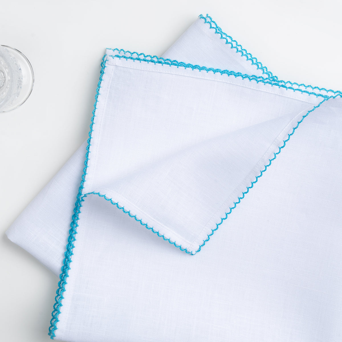 White and blue pure linen dinner napkins styled on a dining table