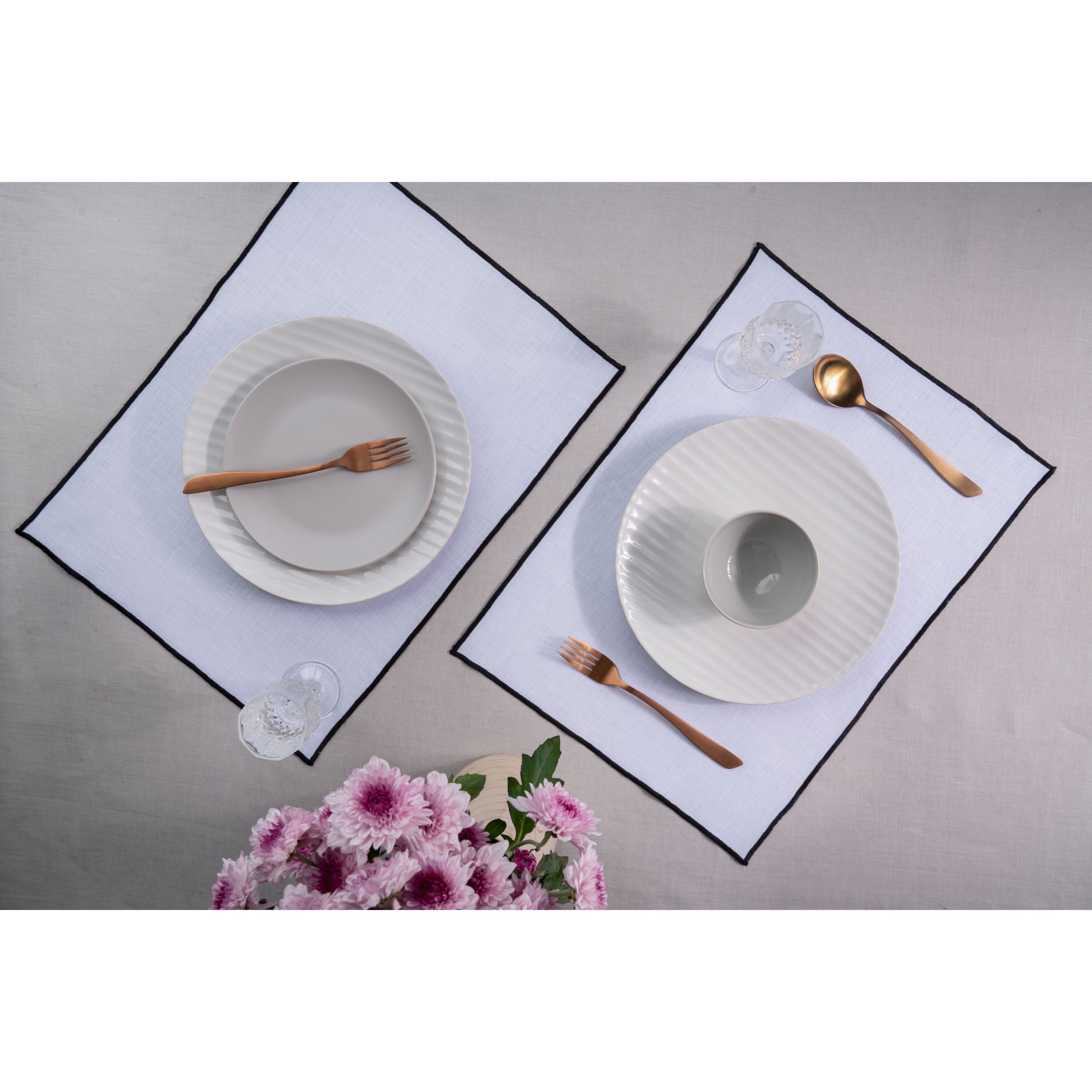 White and black pure linen placemats styled on a dining table