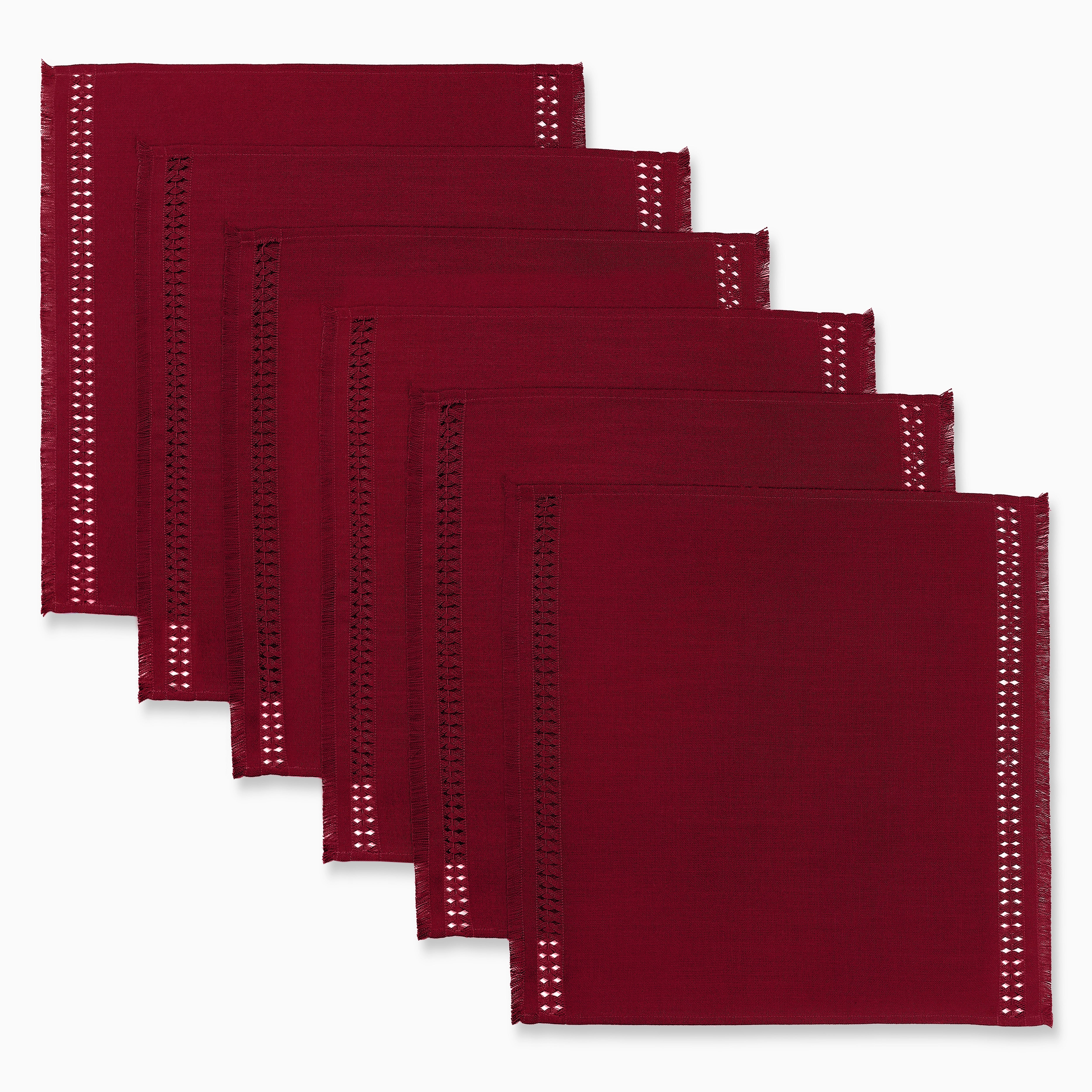 Red faux linen dinner napkins styled on a dining table
