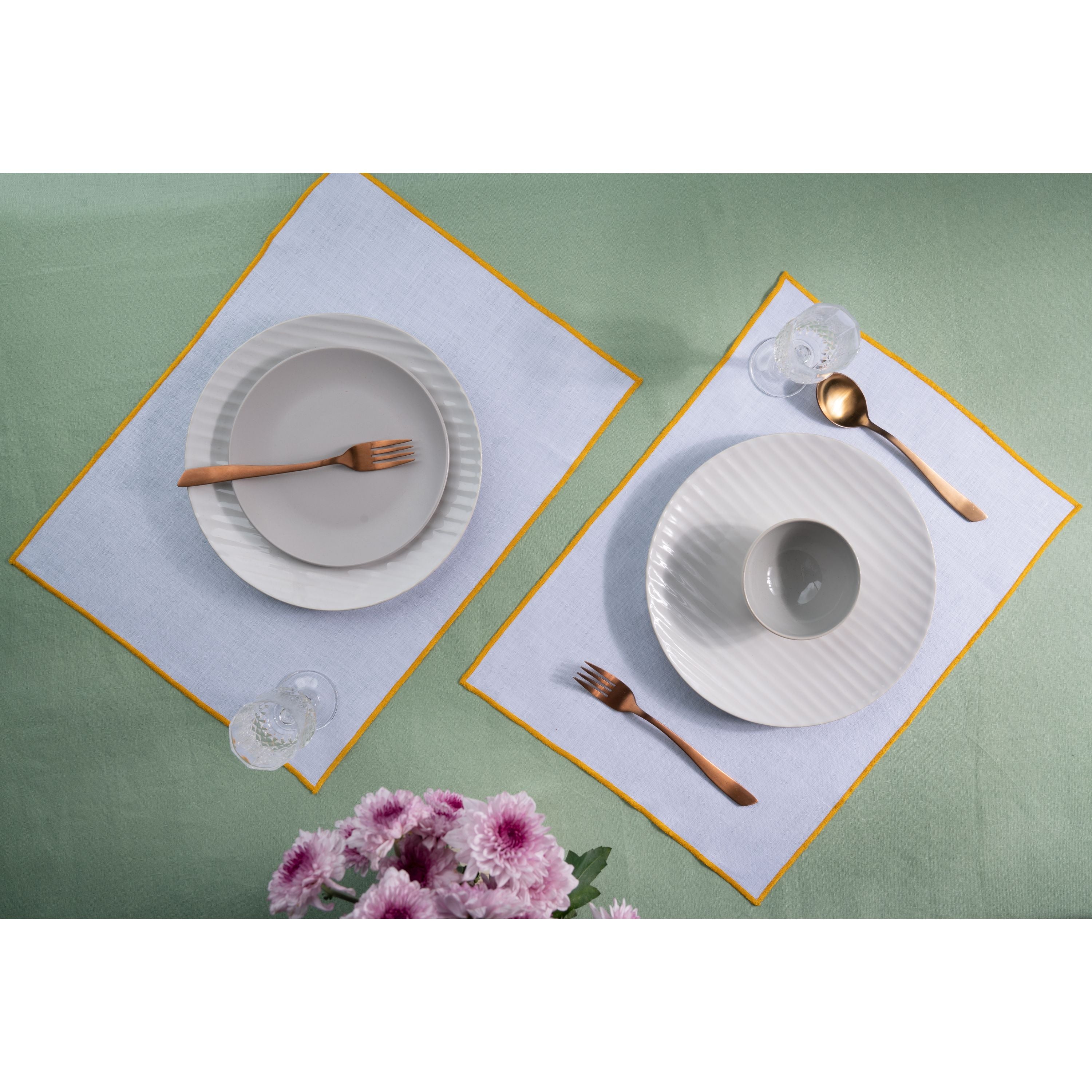 White and yellow pure linen placemats styled on a dining table