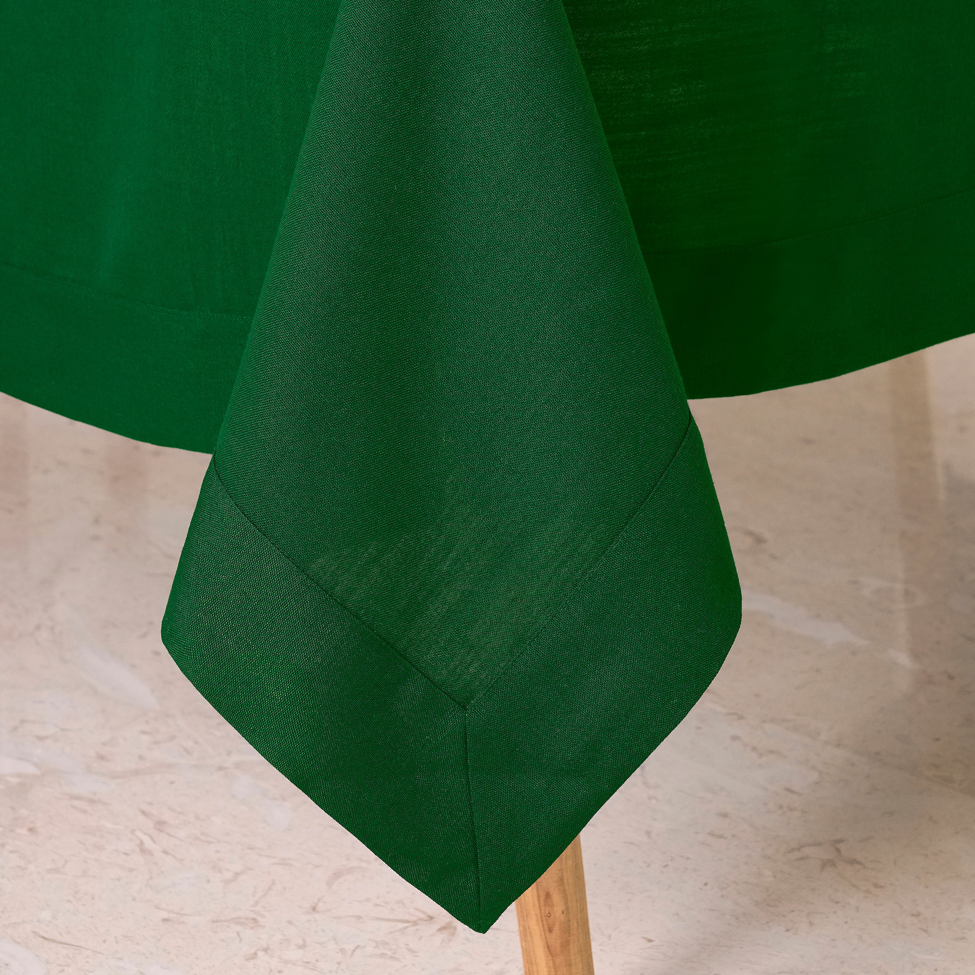 Eden green faux linen tablecloth styled on a dining table