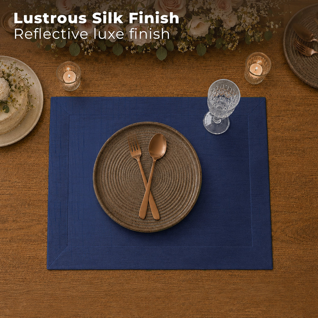 Navy blue Luxe Shine placemats styled on a dining table