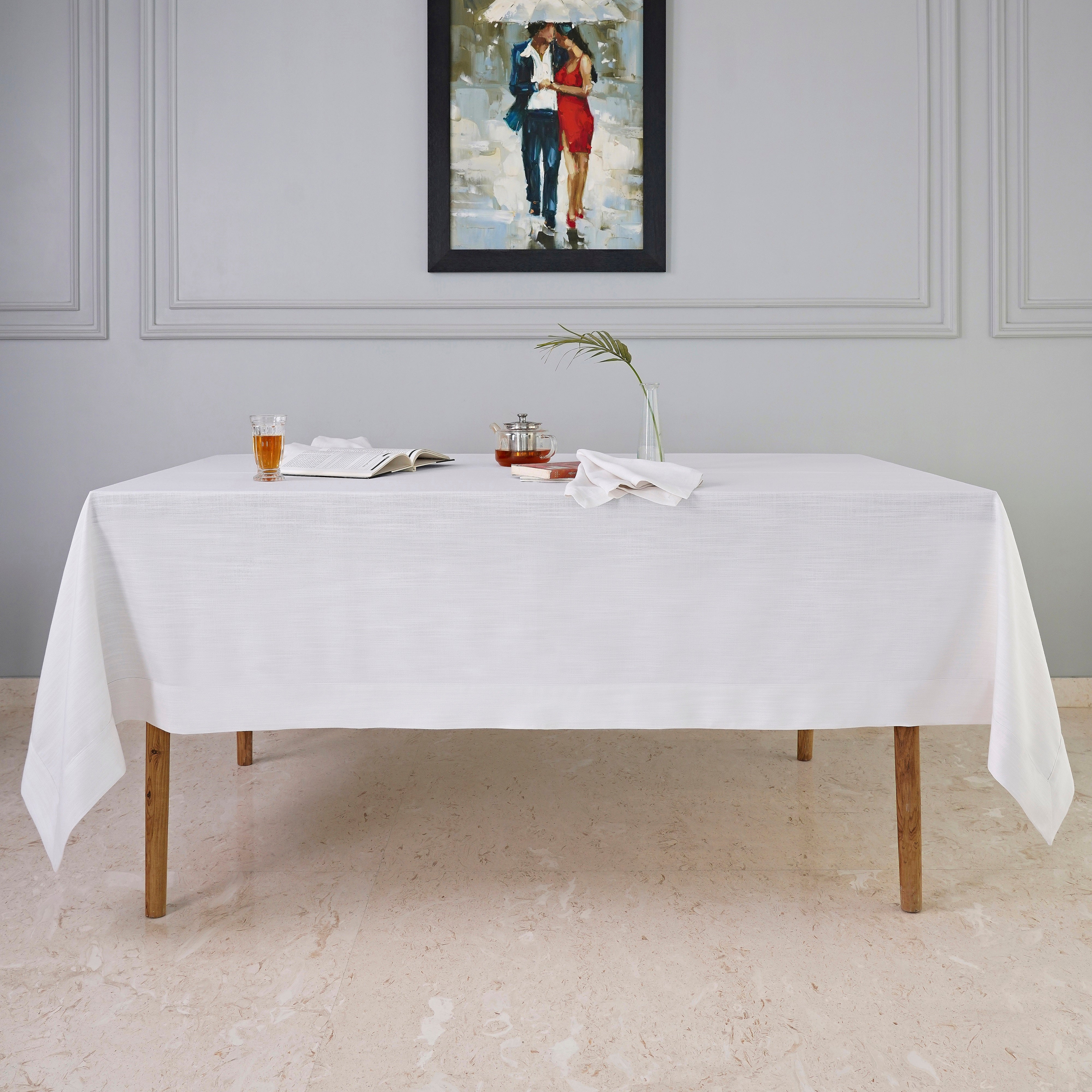 Close-up of the mitered corners on a chambray cream and white faux linen tablecloth