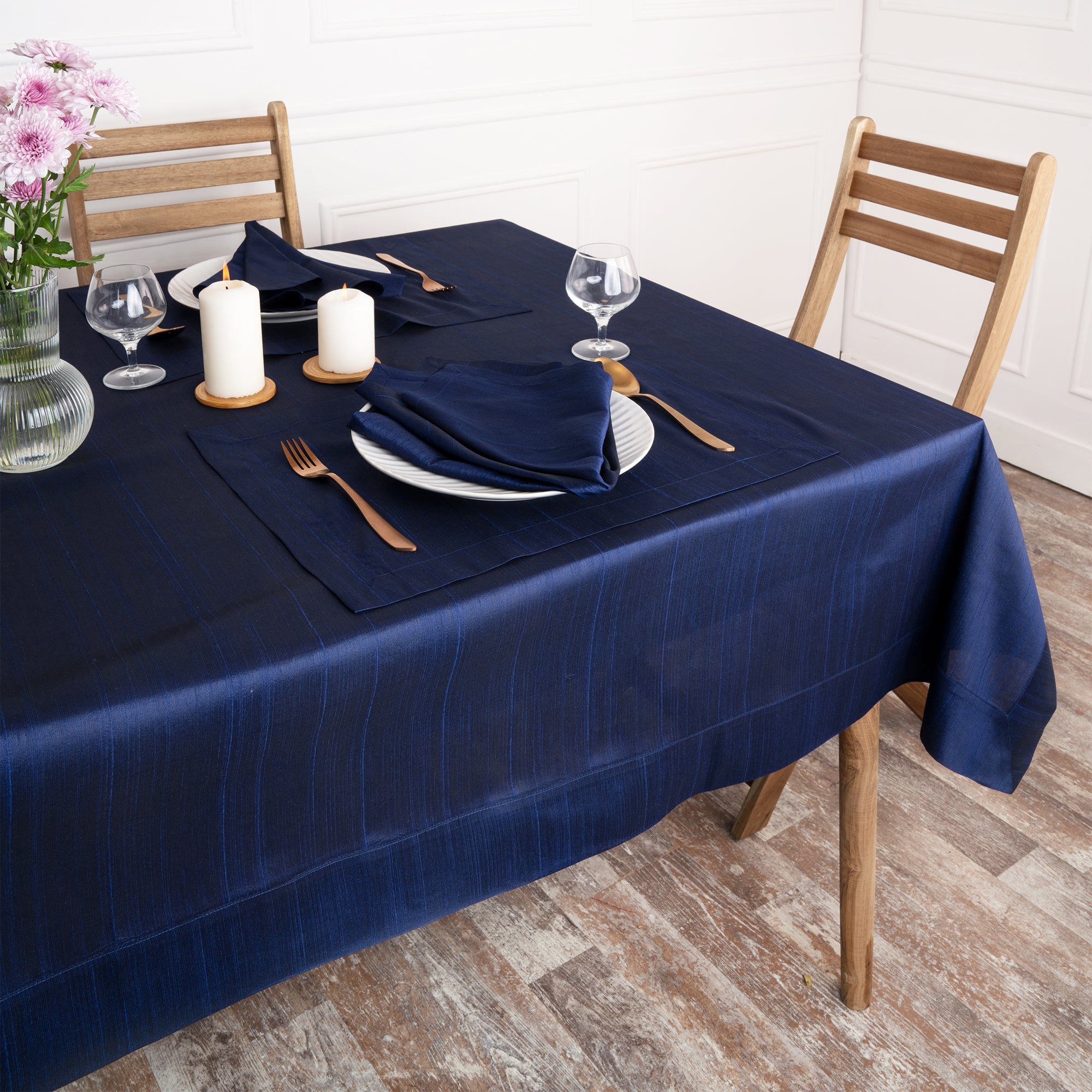 Close-up of the mitered corners on a navy blue Luxe Shine tablecloth