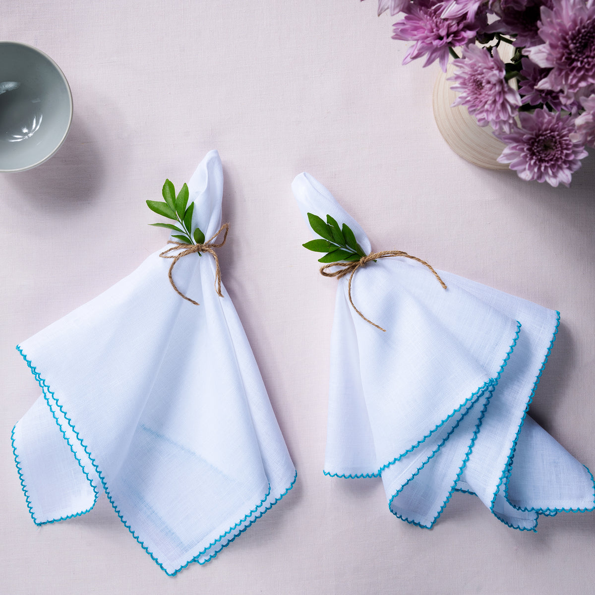 Close-up of the whipstitch edge on white and blue pure linen dinner napkins
