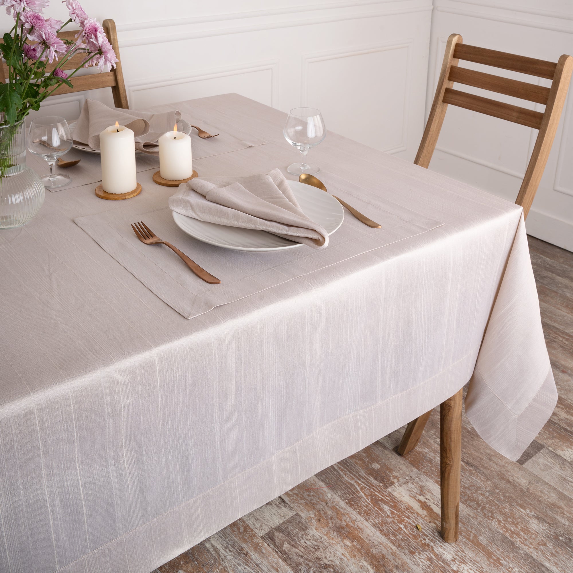Close-up of the mitered corners on a natural Luxe Shine tablecloth