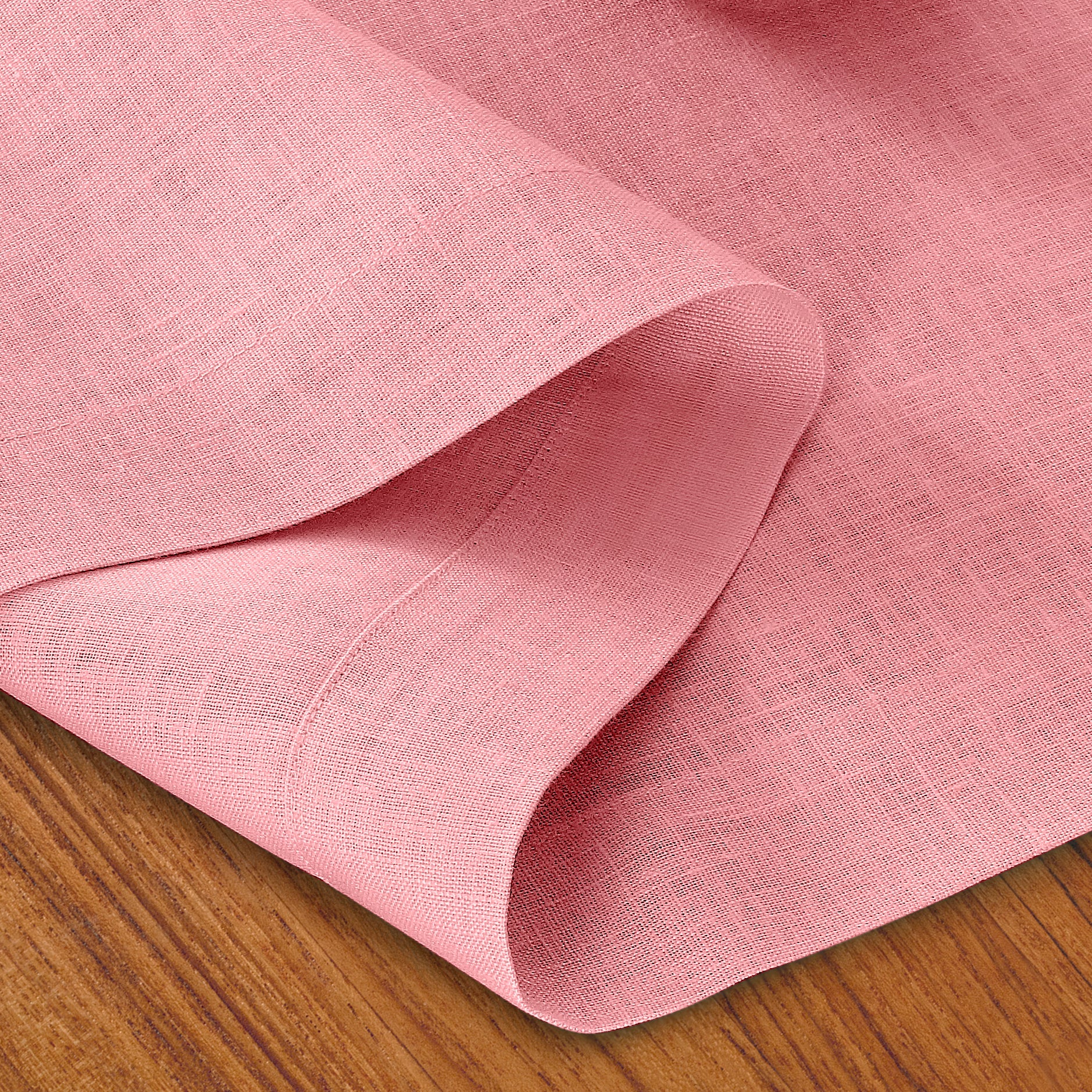 Close-up of the mitered corners on a dusty pink pure linen table runner