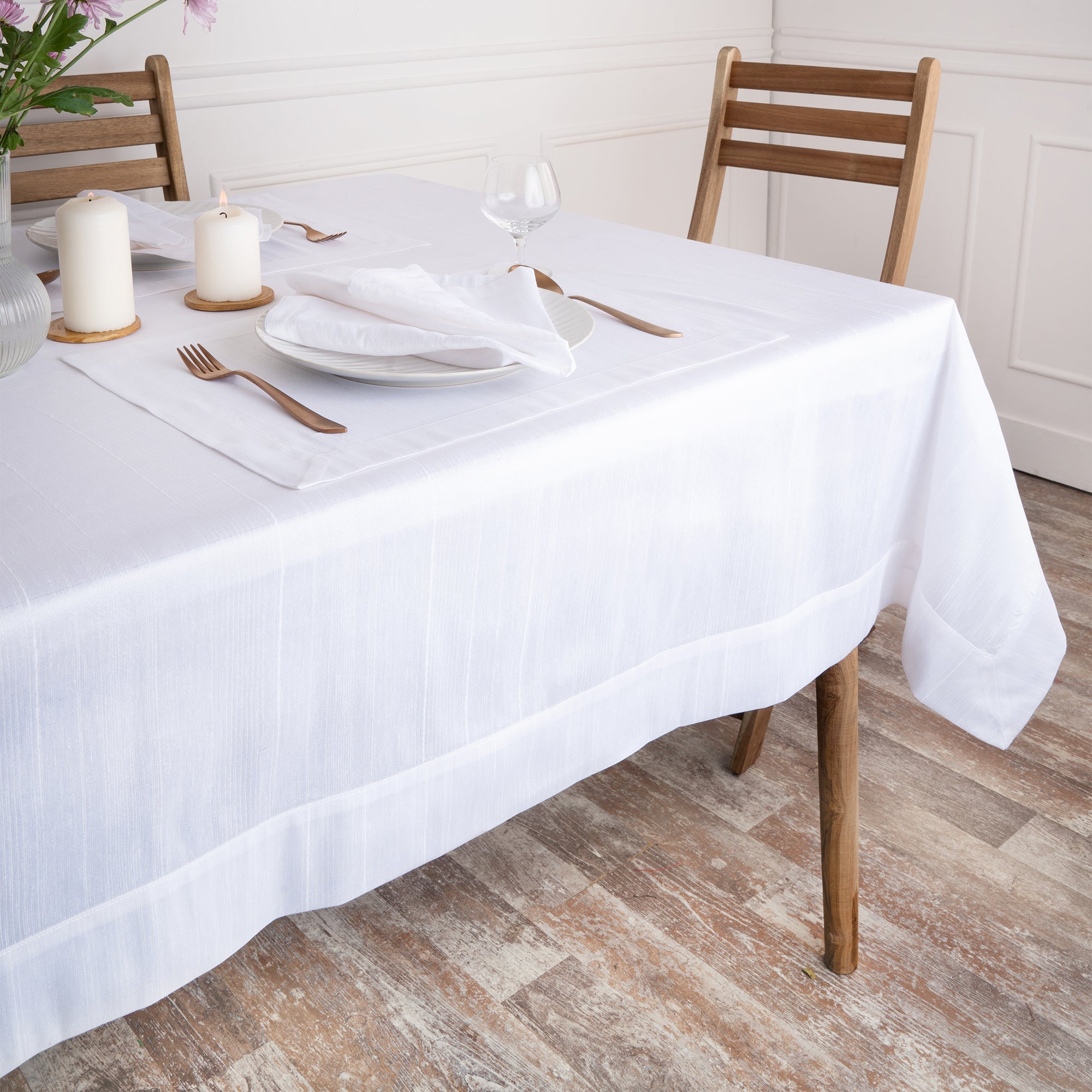 Close-up of the mitered corners on a white Luxe Shine tablecloth