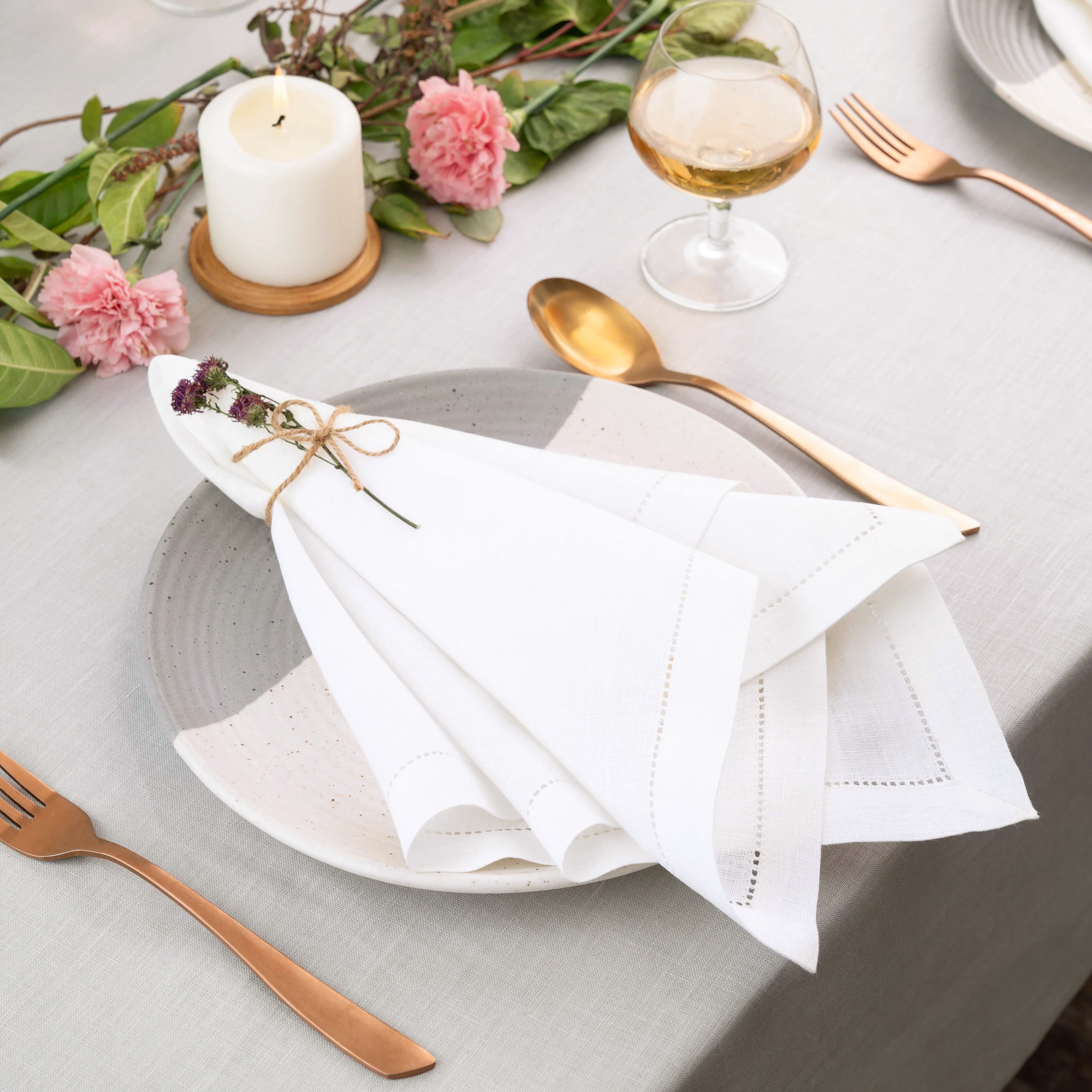 White pure linen dinner napkins styled on a dining table