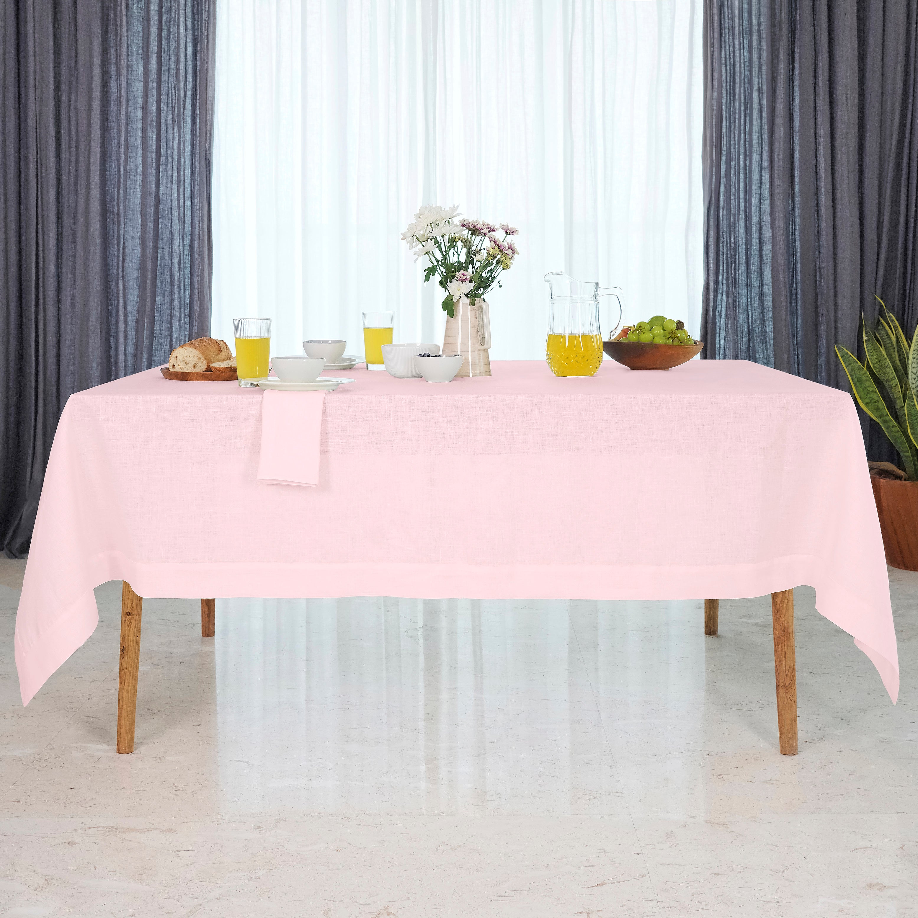 Close-up of the mitered corners on a pastel pink pure linen tablecloth