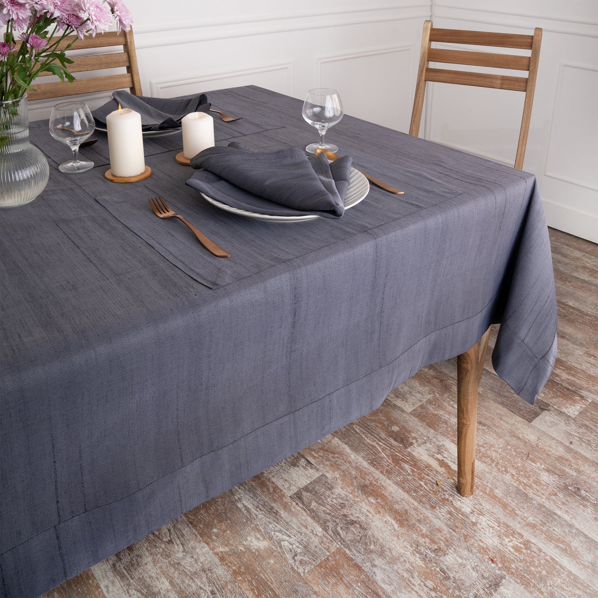 Close-up of the mitered corners on a charcoal grey Luxe Shine tablecloth