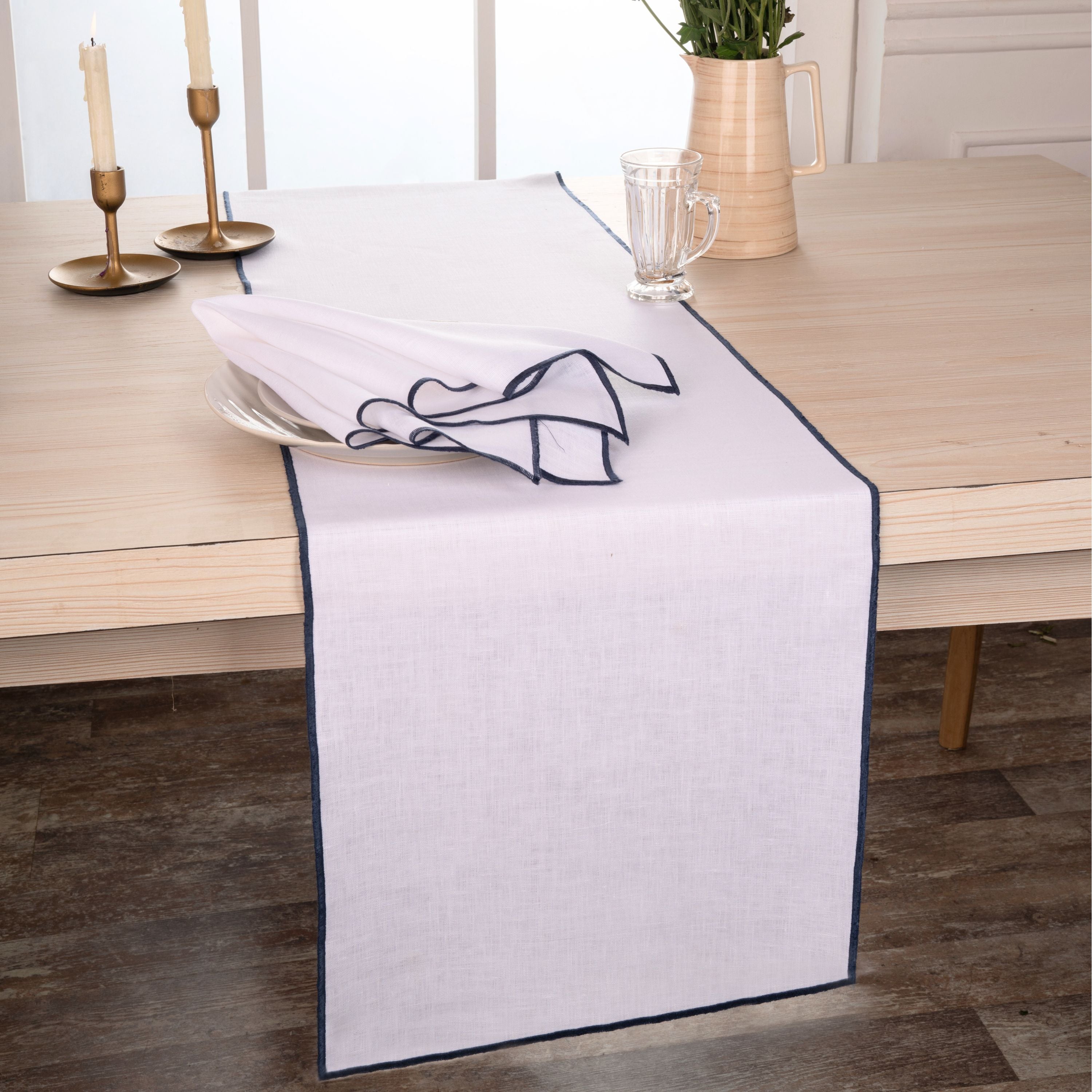 Close-up of the marrow edge on a white and navy blue pure linen table runner