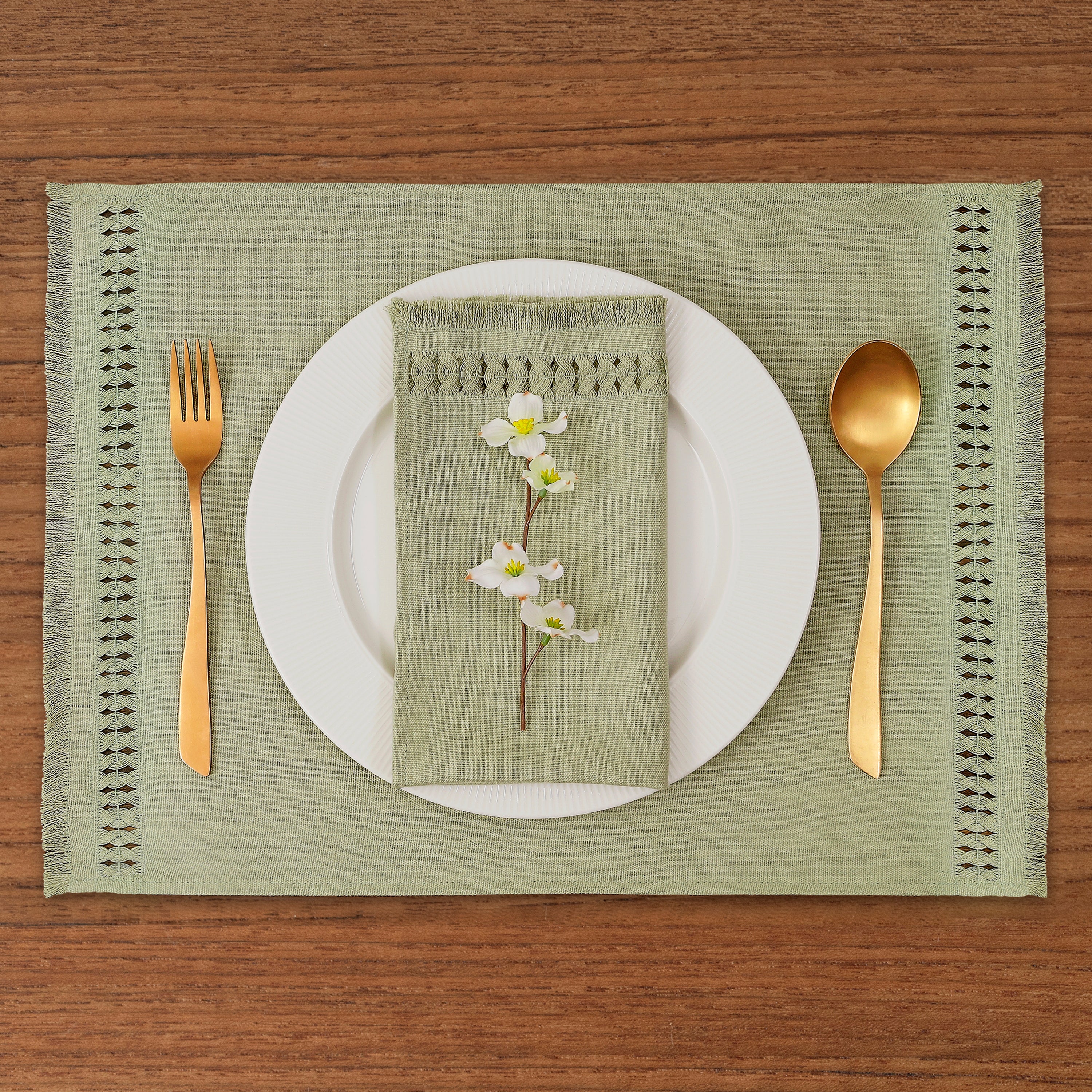 Close-up of the hand-hemstitch edge on sage green faux linen placemats