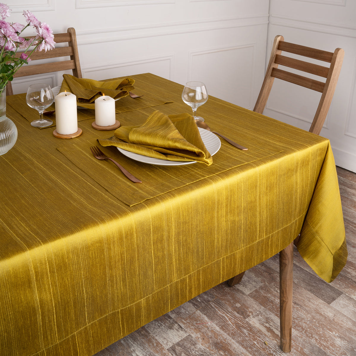 Close-up of the mitered corners on a gold Luxe Shine tablecloth