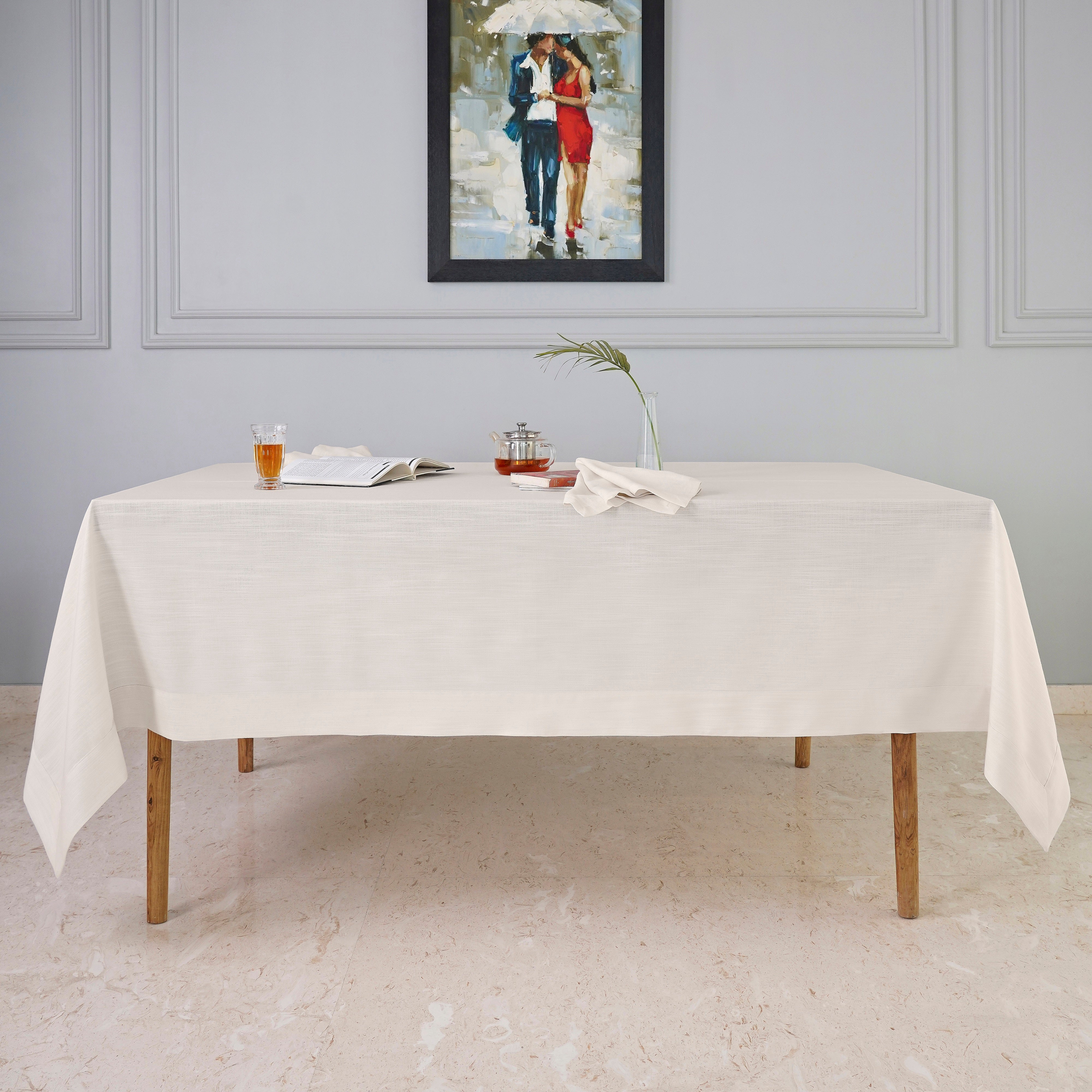 Close-up of the mitered corners on an ivory faux linen tablecloth